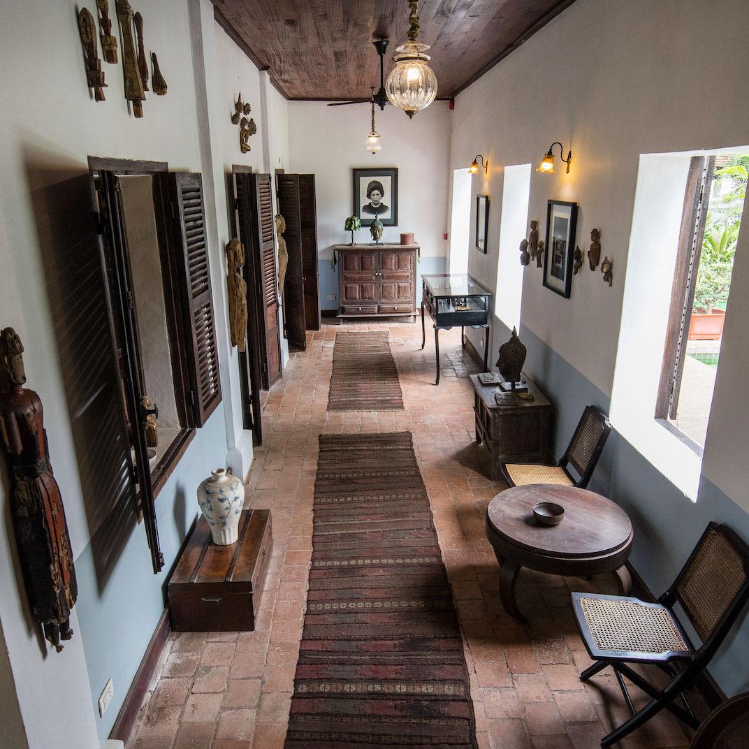 A long hallway furnished with dark wood