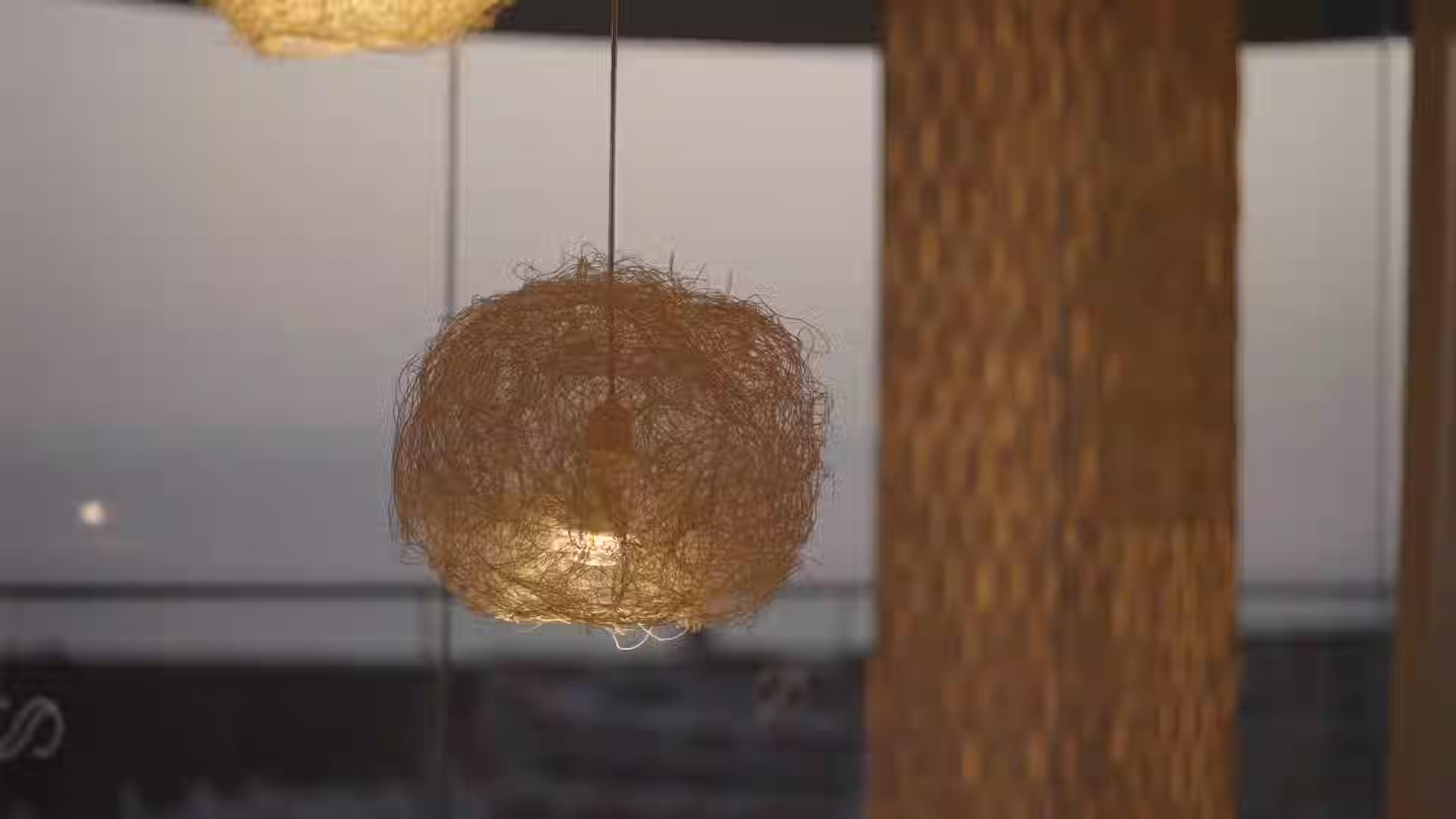 A woven pendant lamp over the dining room at El Rincón de Juan Carlos