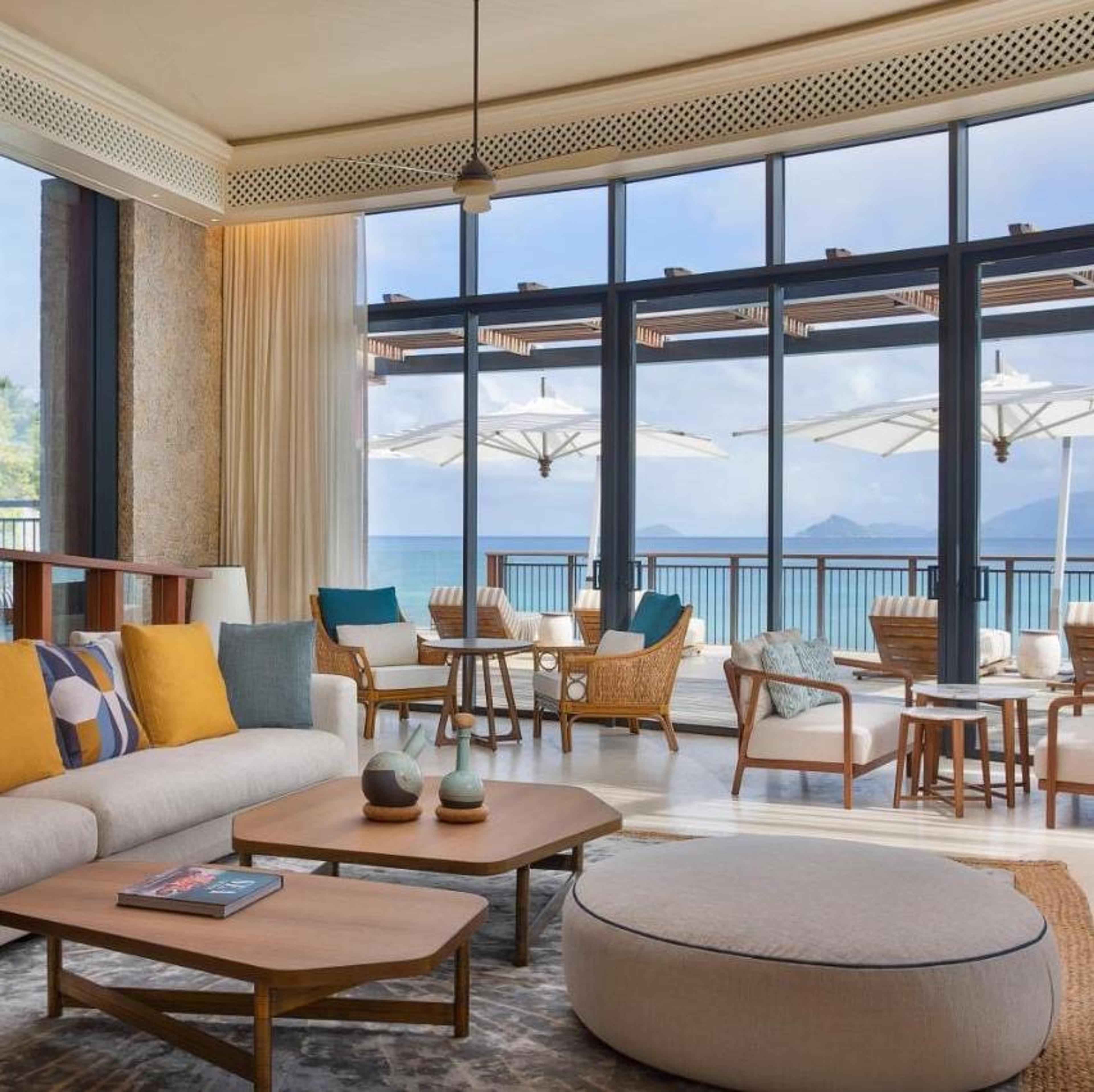 A living room with tall windows onto the bay