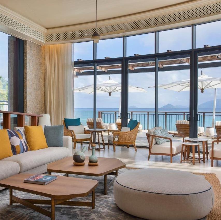 A living room with tall windows onto the bay