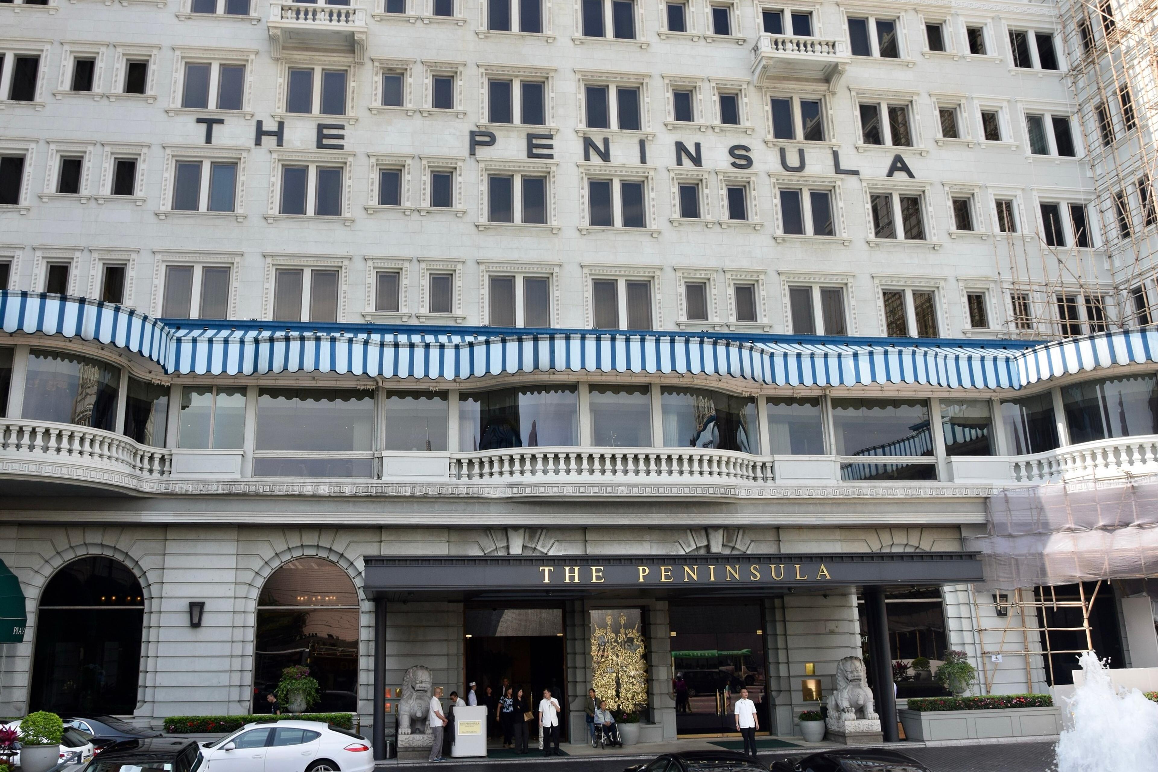 The hotel's white facade with its name across the top and the entrance canopy below