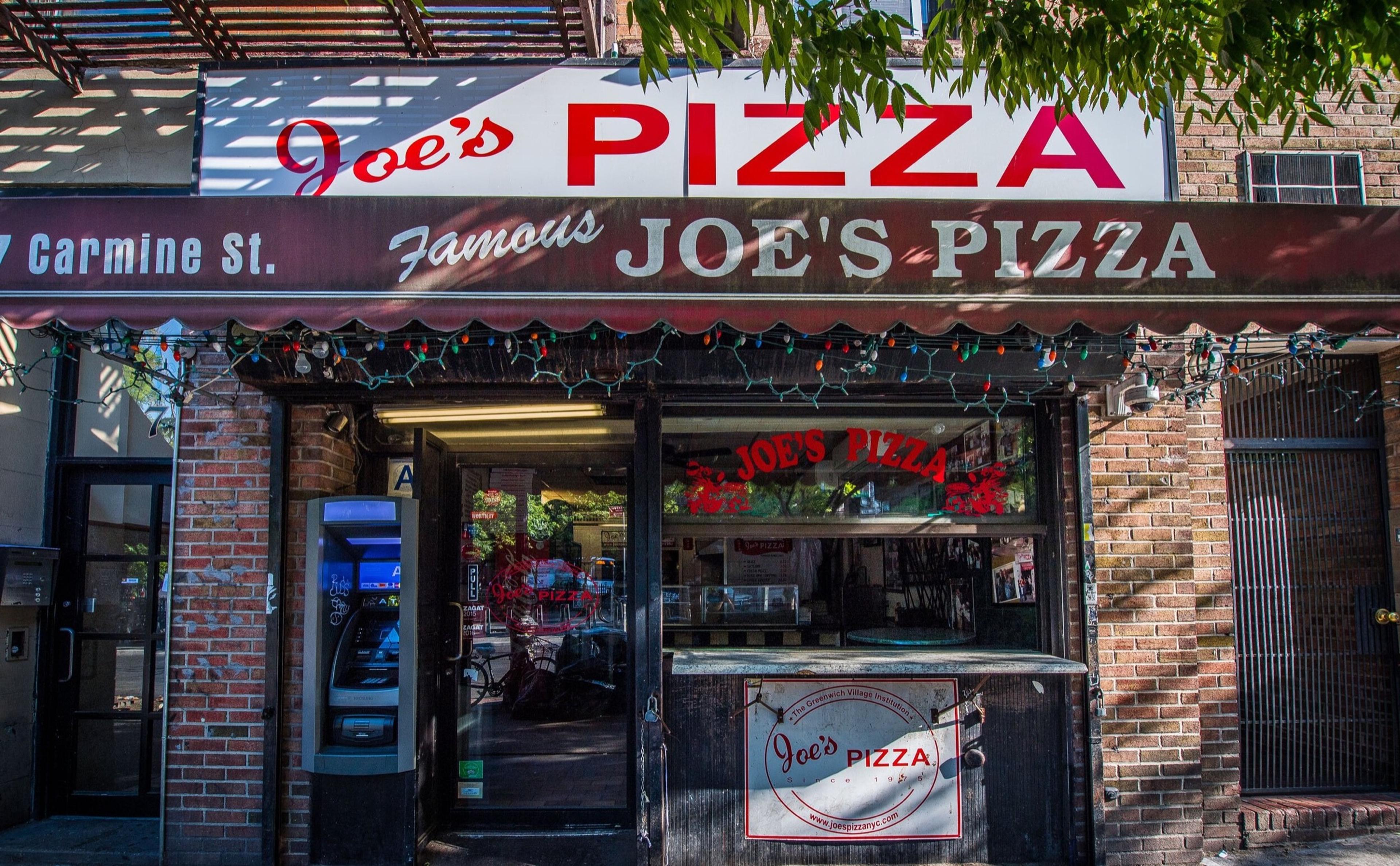 The red and white sign over the small shopfront of Joe's Pizza on a Greenwich Village corner