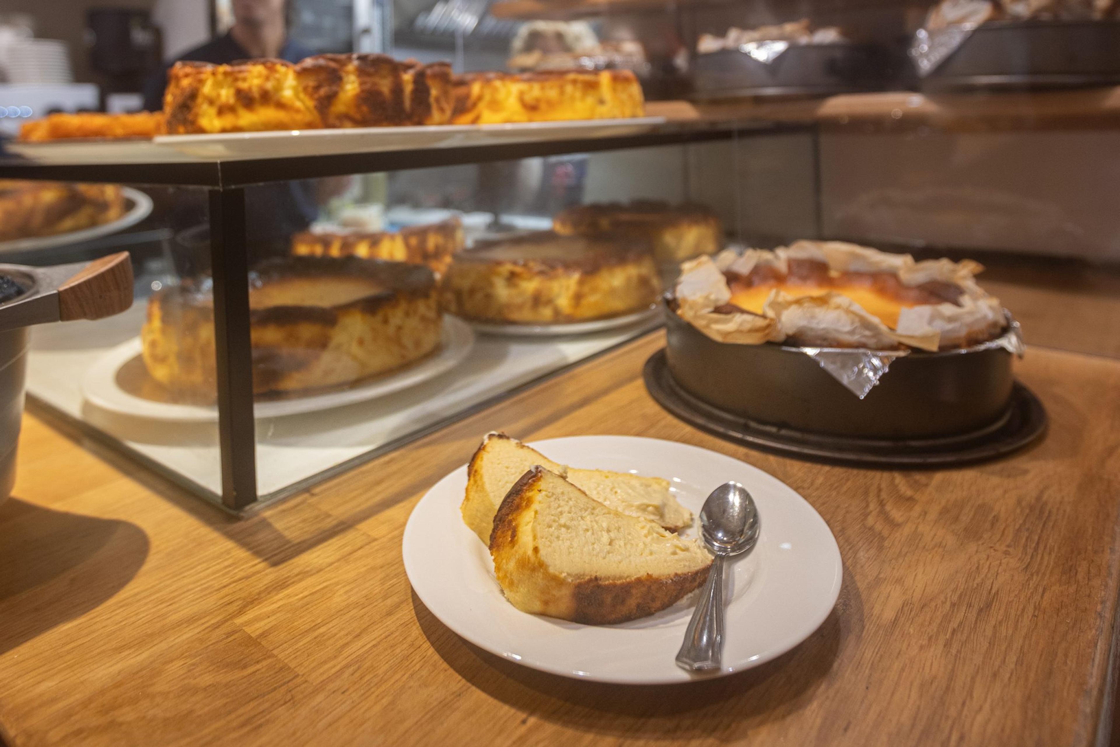 La Viña's burnt cheesecakes on the bar, one cut and served on a plate
