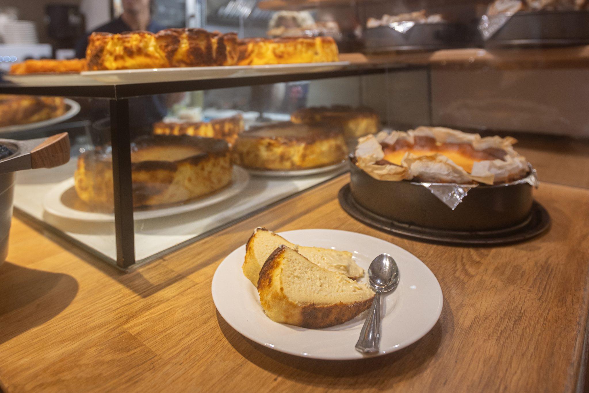 La Viña's burnt cheesecakes on the bar, one cut and served on a plate