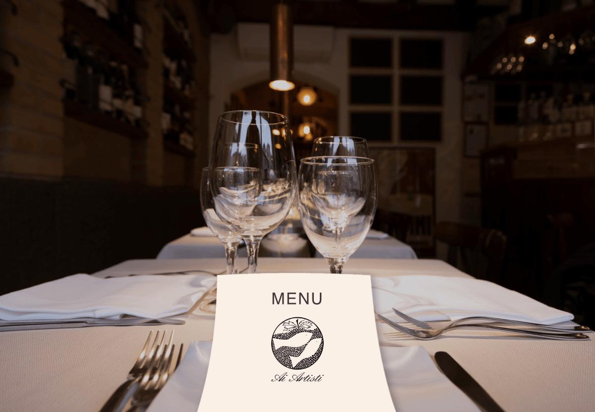 A table laid with wine glasses and a menu card