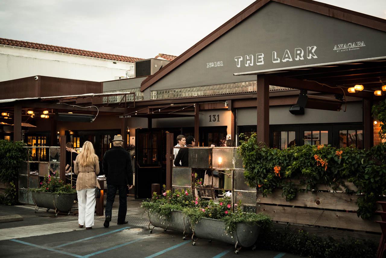 The Lark's covered patio in the Funk Zone, its name painted on the roof edge above the diners