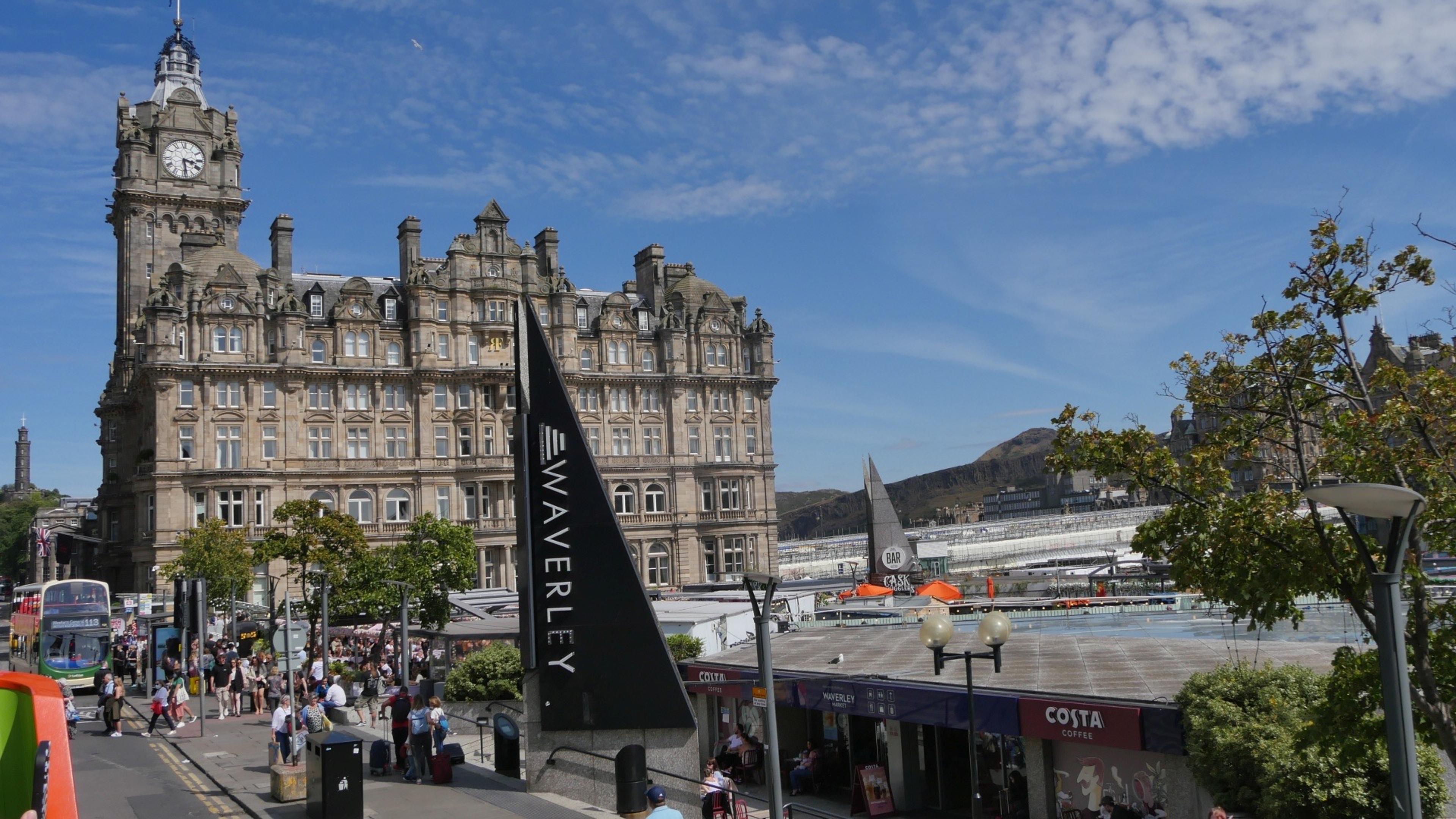 The Balmoral above the Waverley Station entrance, with people crossing the square below.