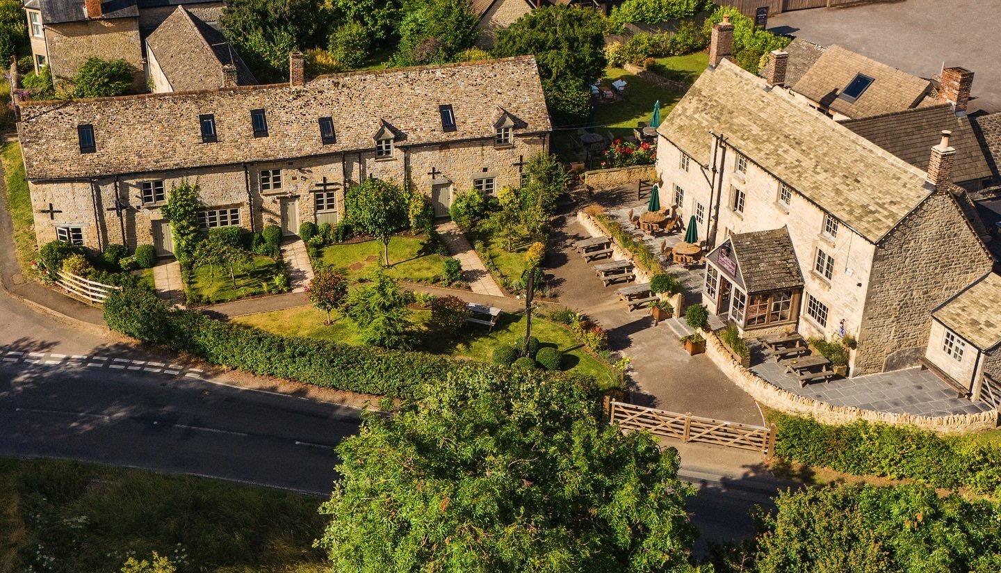The stone coaching inn and its gardens seen from above