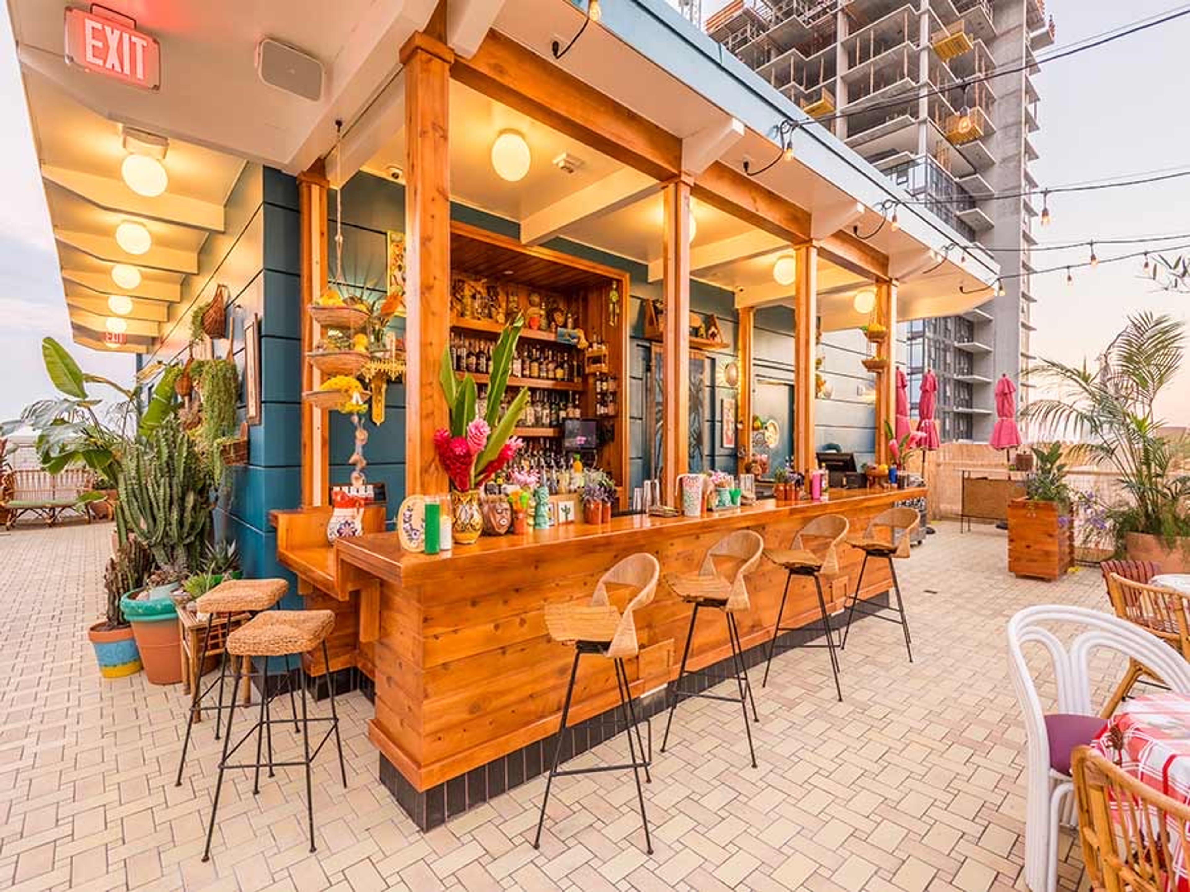 Broken Shaker's rooftop bar on the Freehand in downtown Los Angeles, a wooden counter under a striped awning