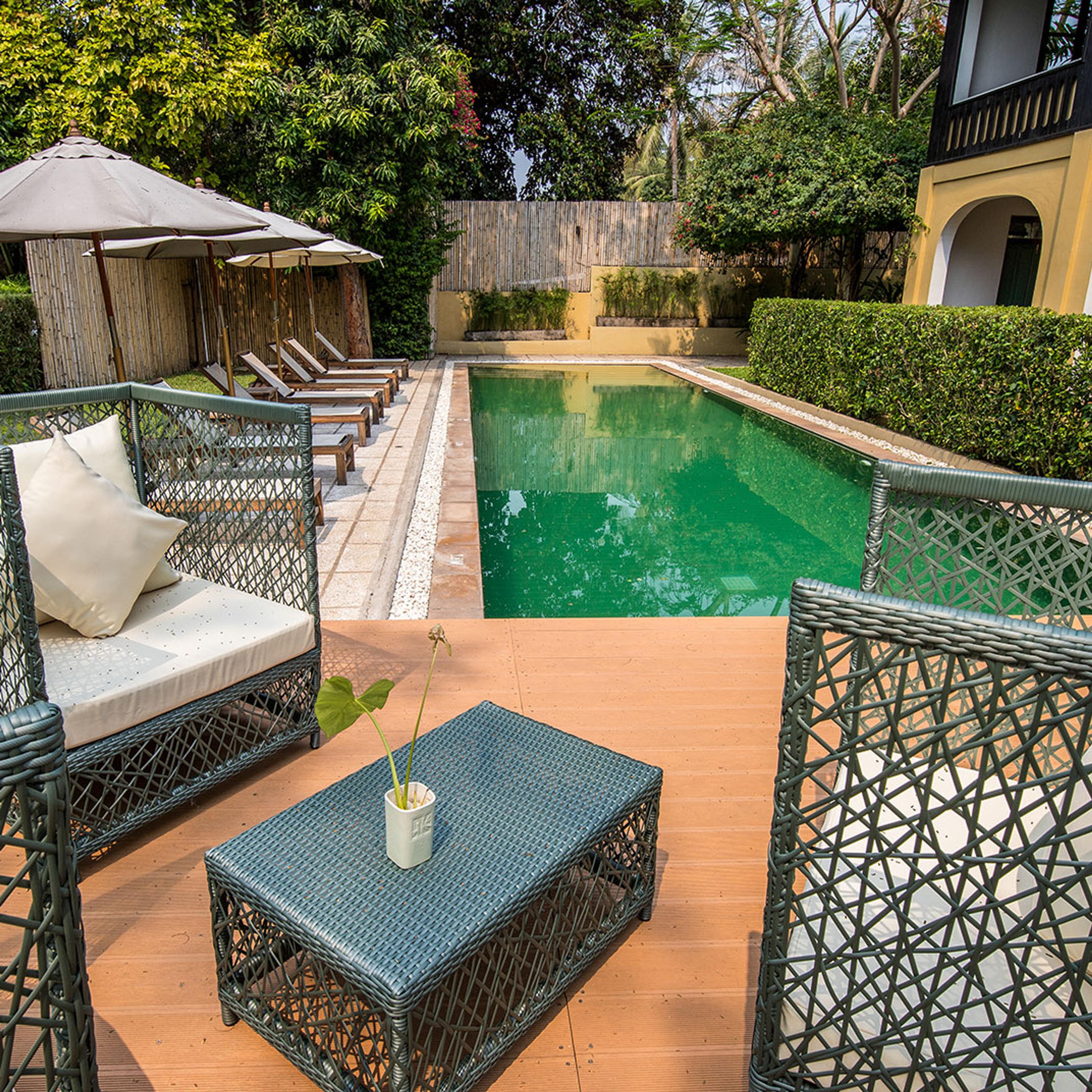 The pool seen from a terrace under latticed screens