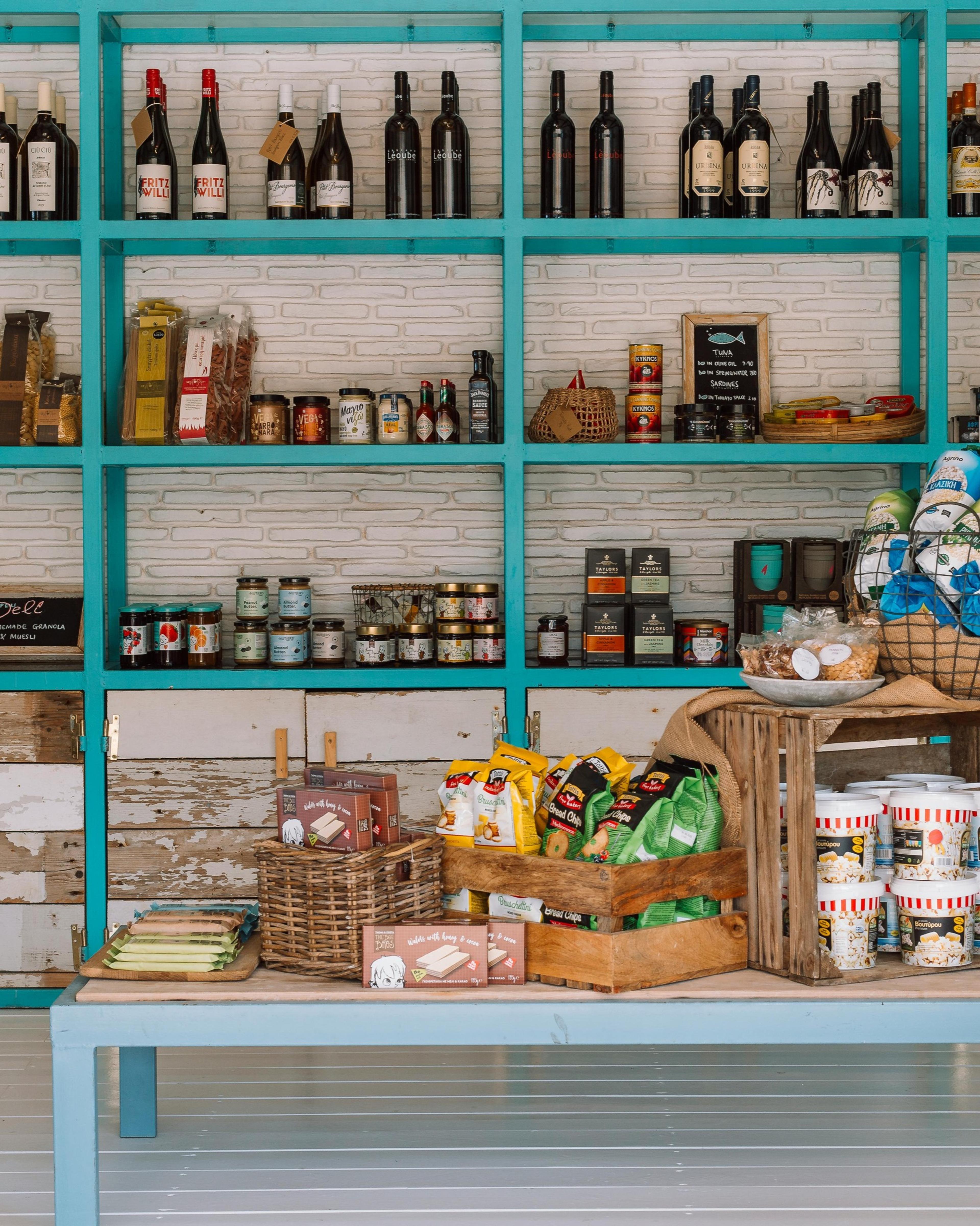 Turquoise shelves in a deli stocked with jars, bottles and packets
