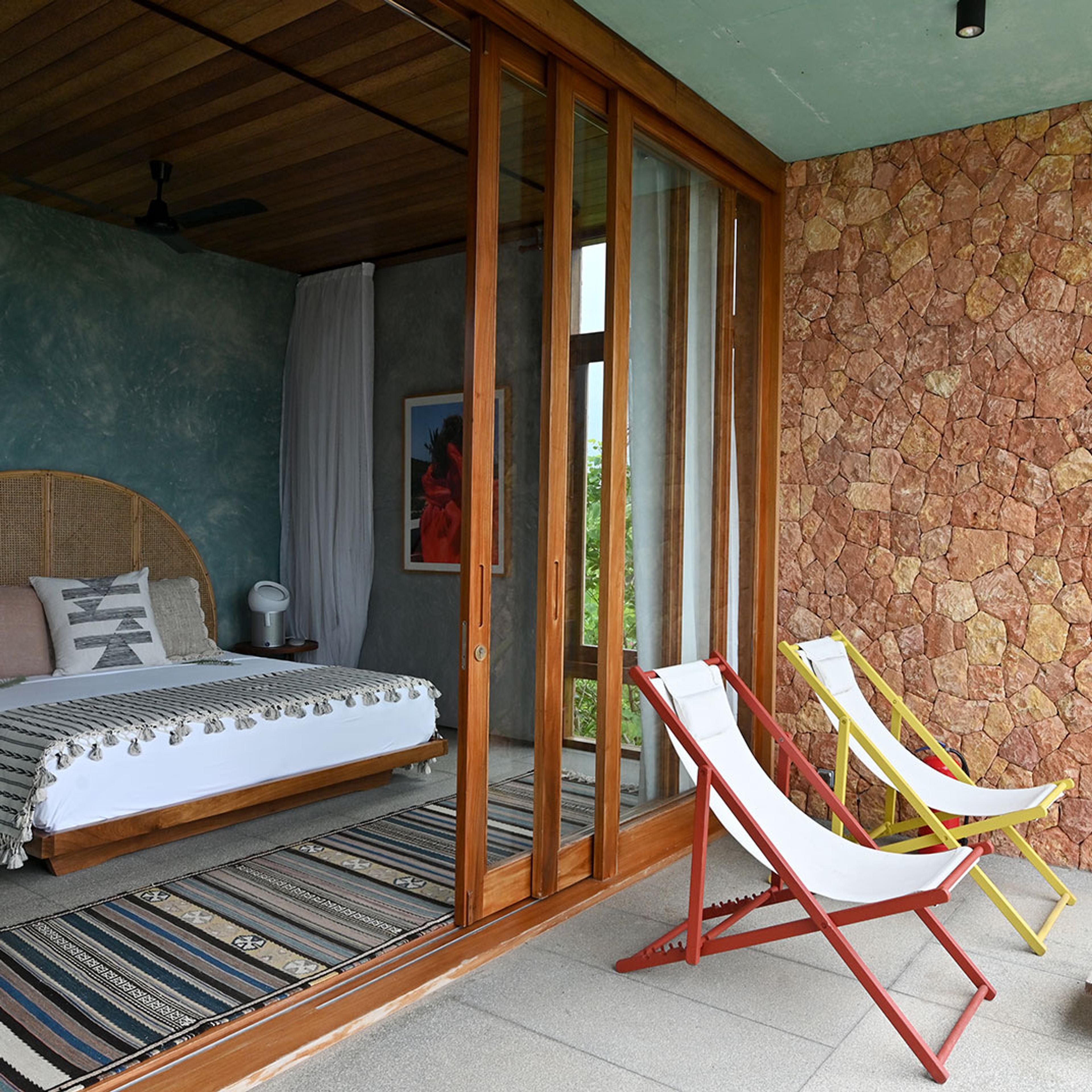 A bedroom with walls of pink coral stone