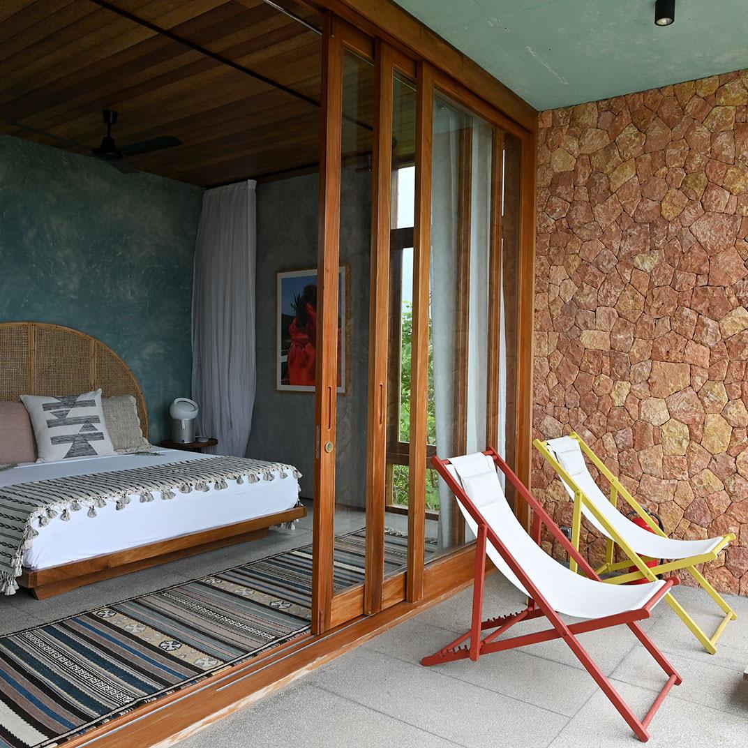 A bedroom with walls of pink coral stone