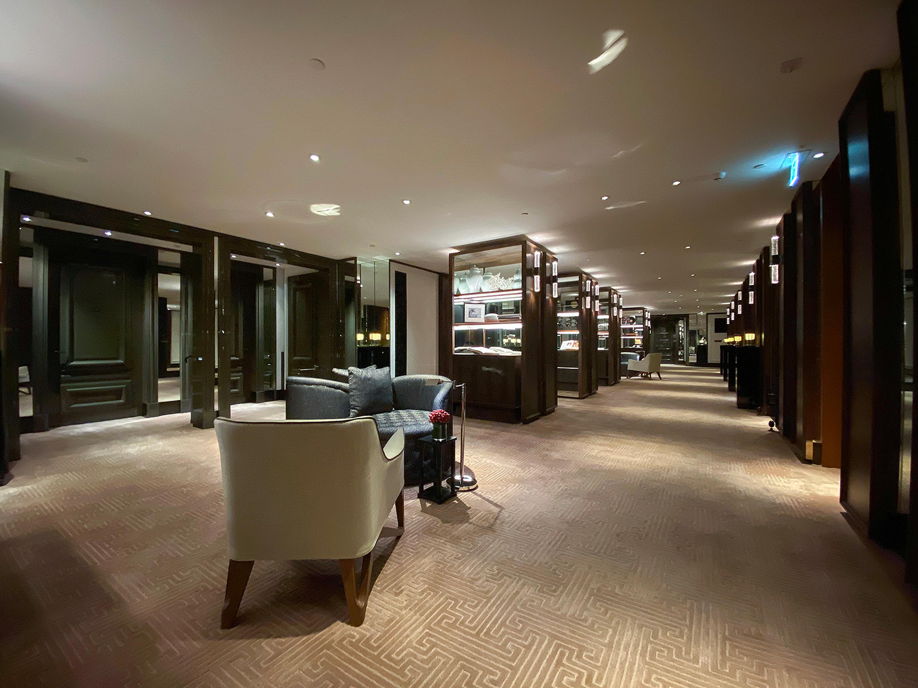 A long lobby lounge with armchairs and low lighting