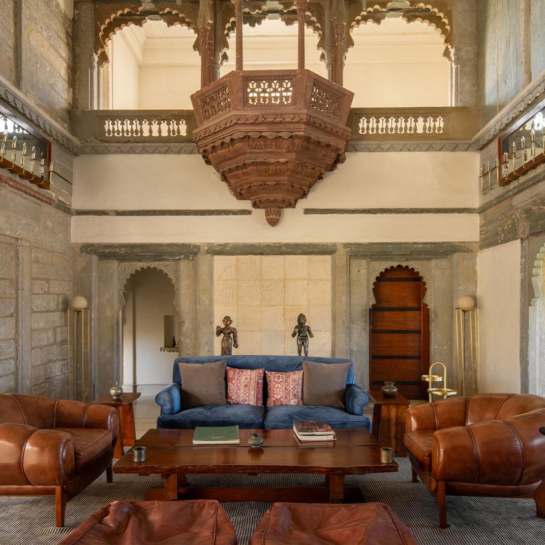 A hall with a chandelier and low seating