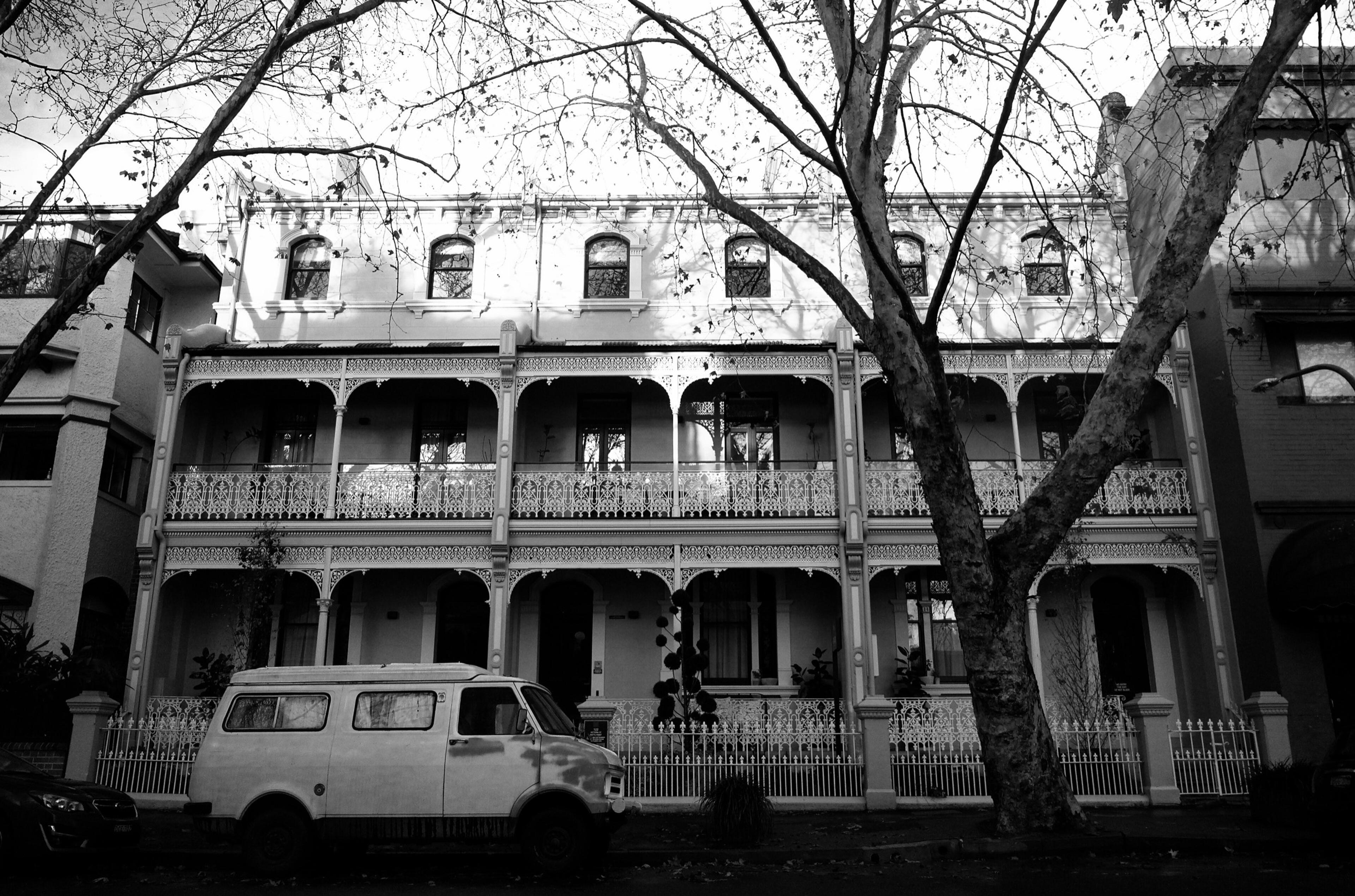 The row of Victorian terraces on Victoria Street with their wrought-iron balconies, in black and white
