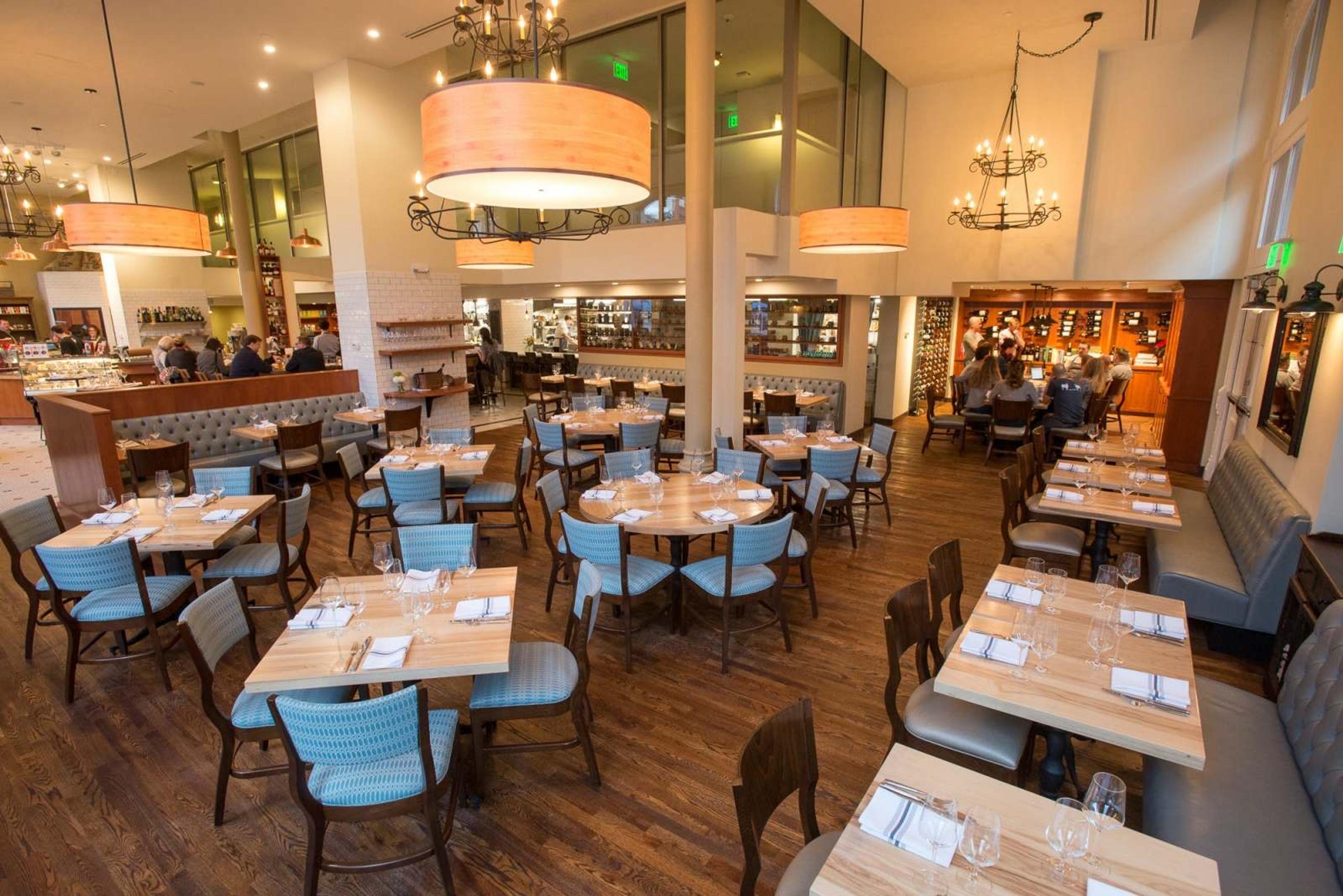 The dining room at Mercantile in Union Station, pale wood tables under drum lamps