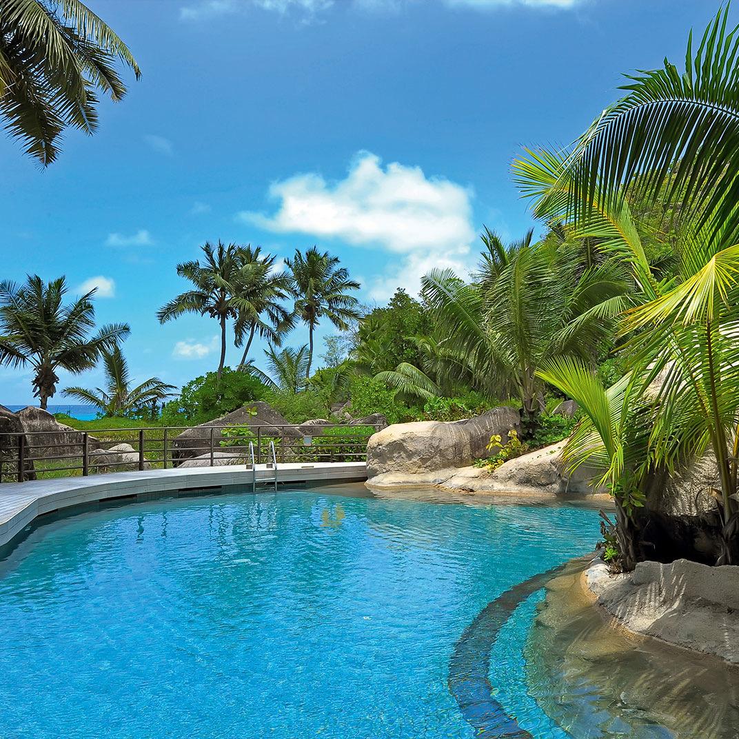 A pool among palms and granite