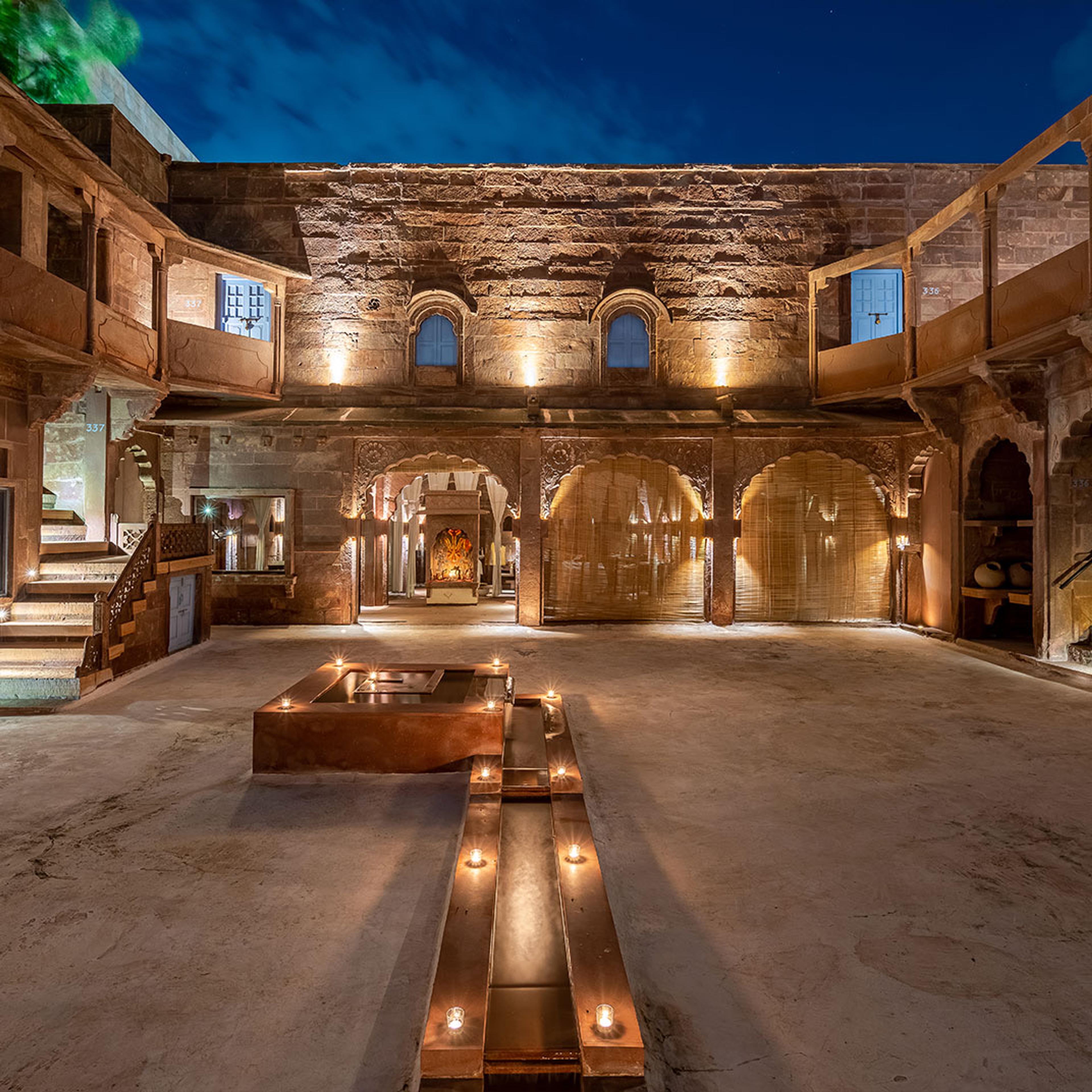 A sandstone courtyard lit in the evening