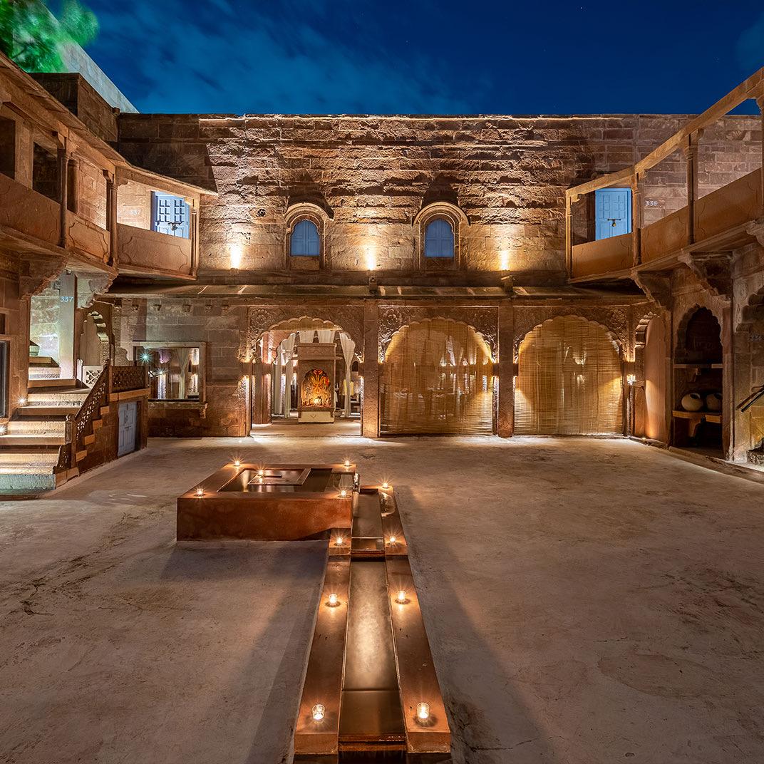 A sandstone courtyard lit in the evening