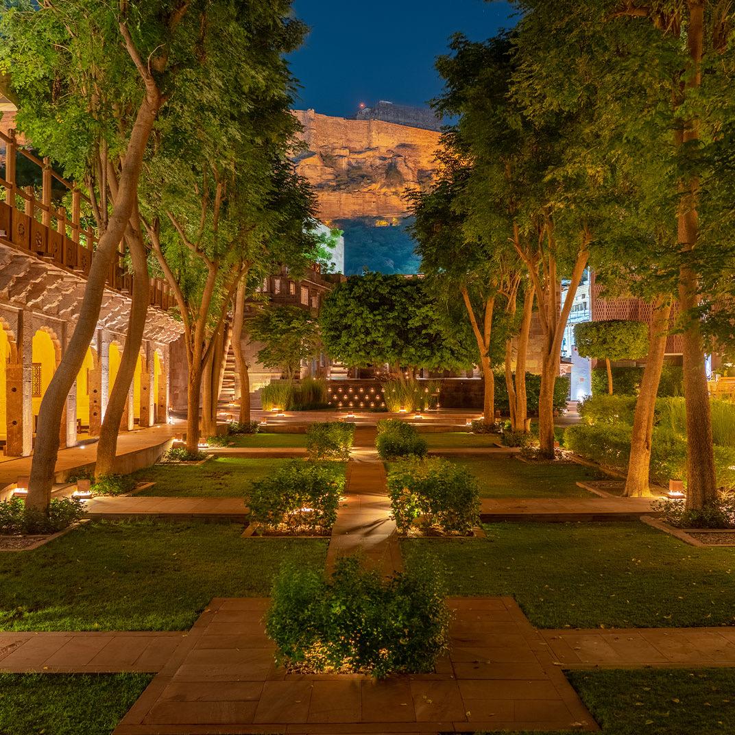 A garden courtyard lit at night