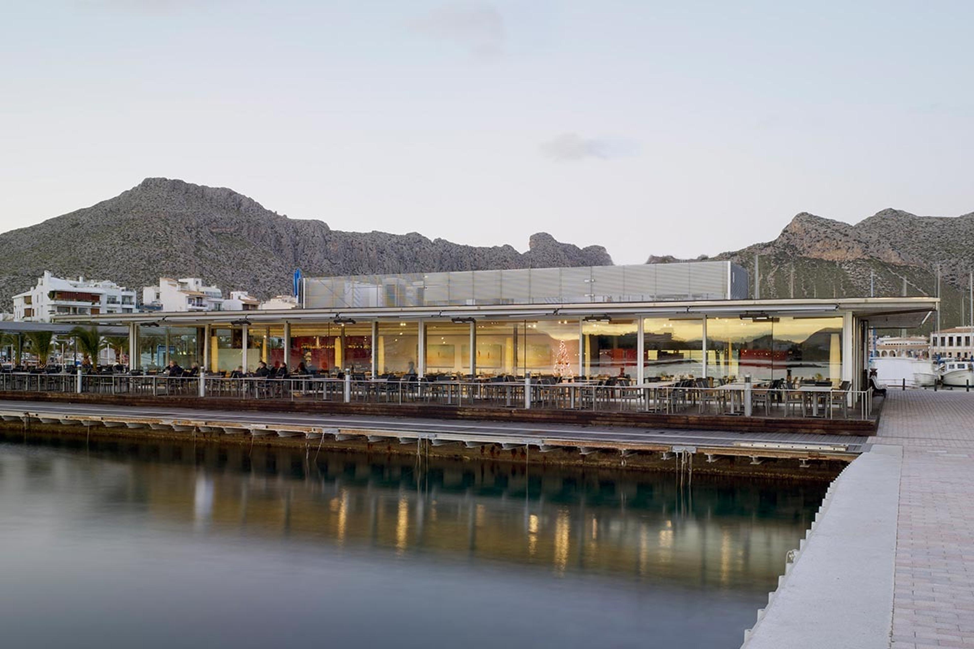 Stay restaurant on its pier over the water at Port de Pollença, the mountains behind