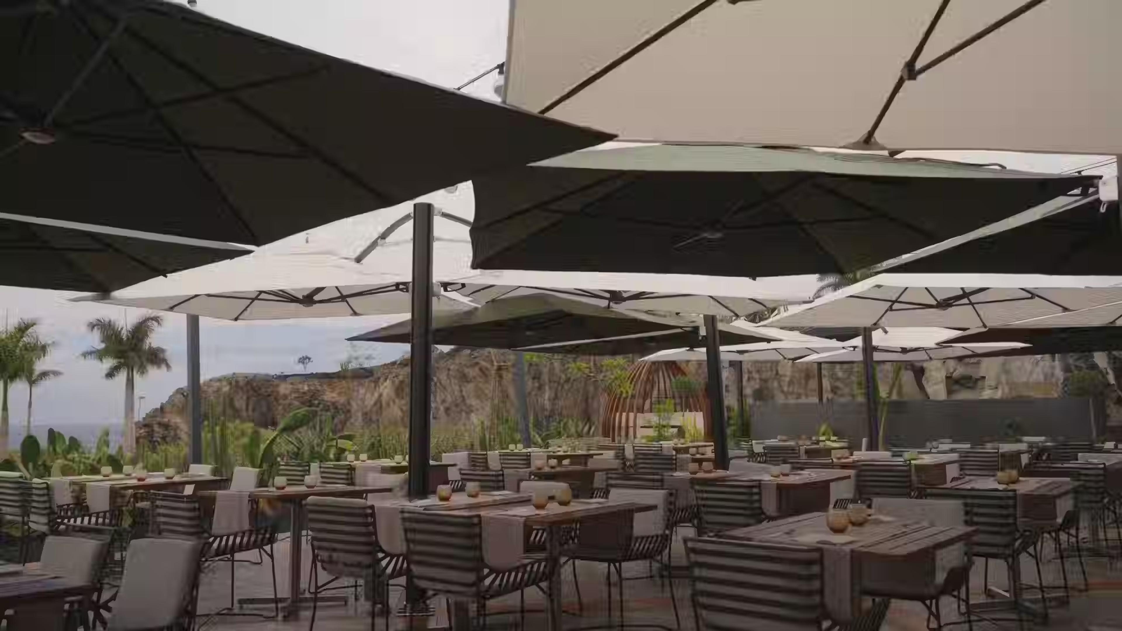 Tables under large parasols on the Trattoria by Il Bocconcino terrace