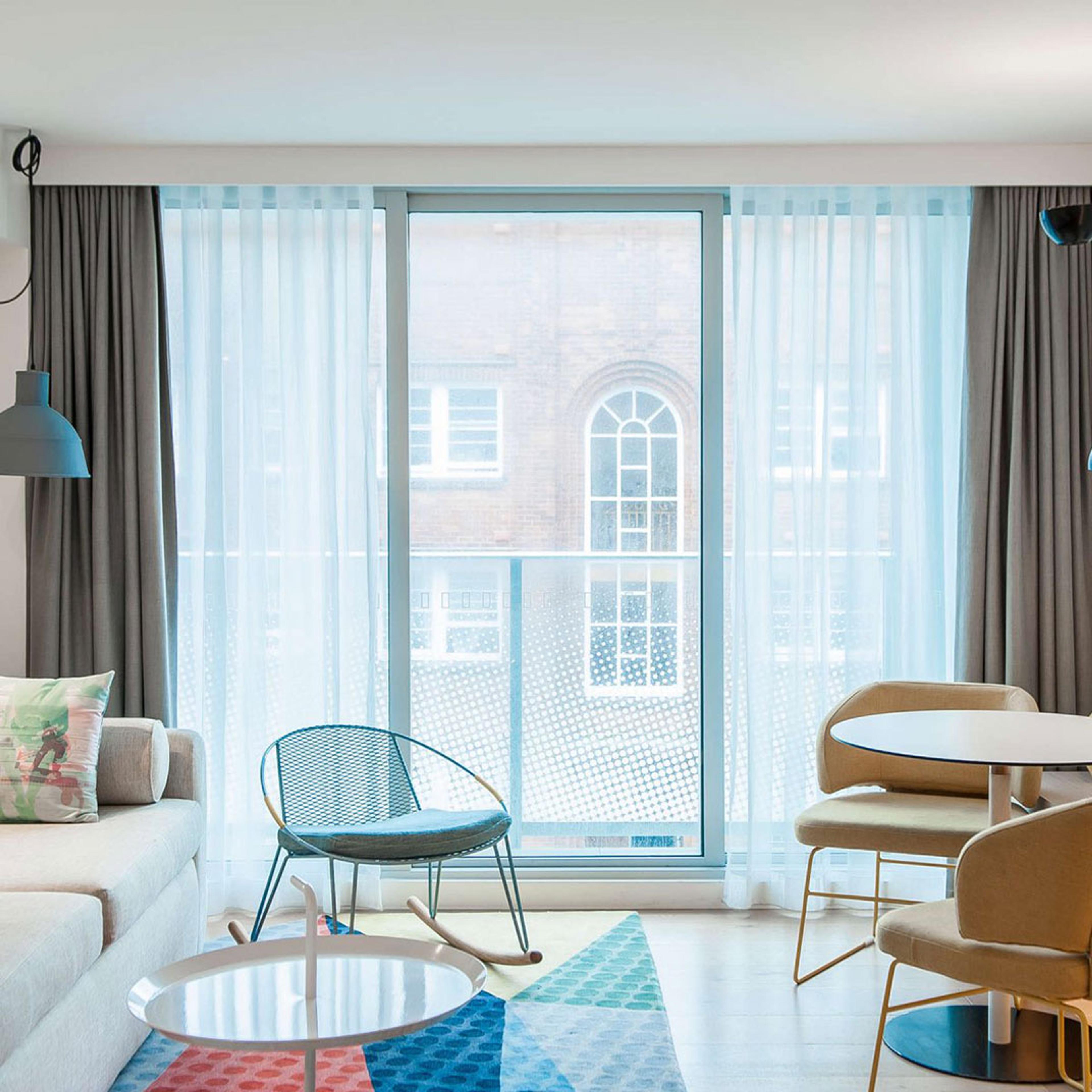 A room opening through glass doors onto a balcony