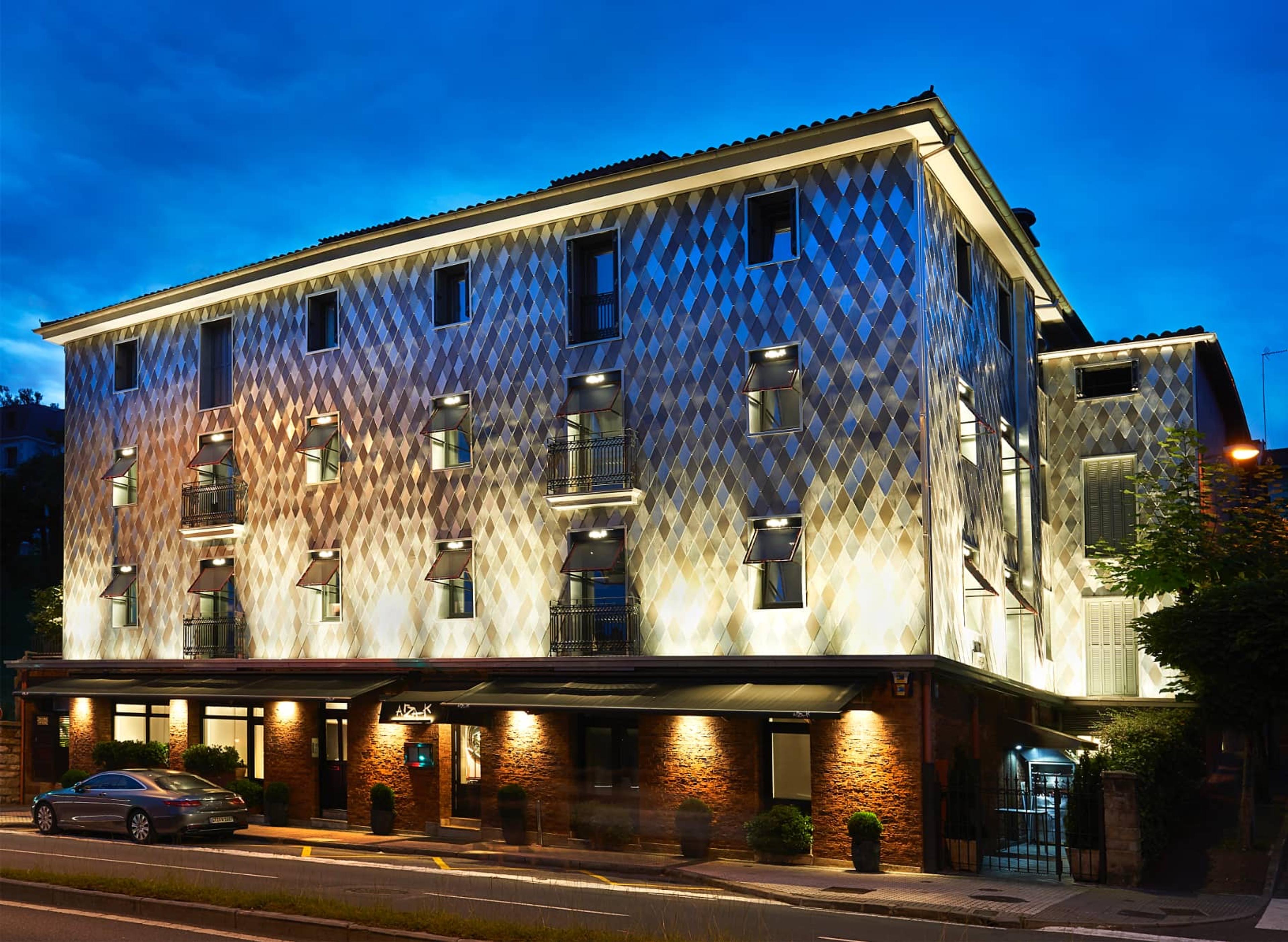 Arzak's house in San Sebastián at night, its front lit up under a deep blue sky