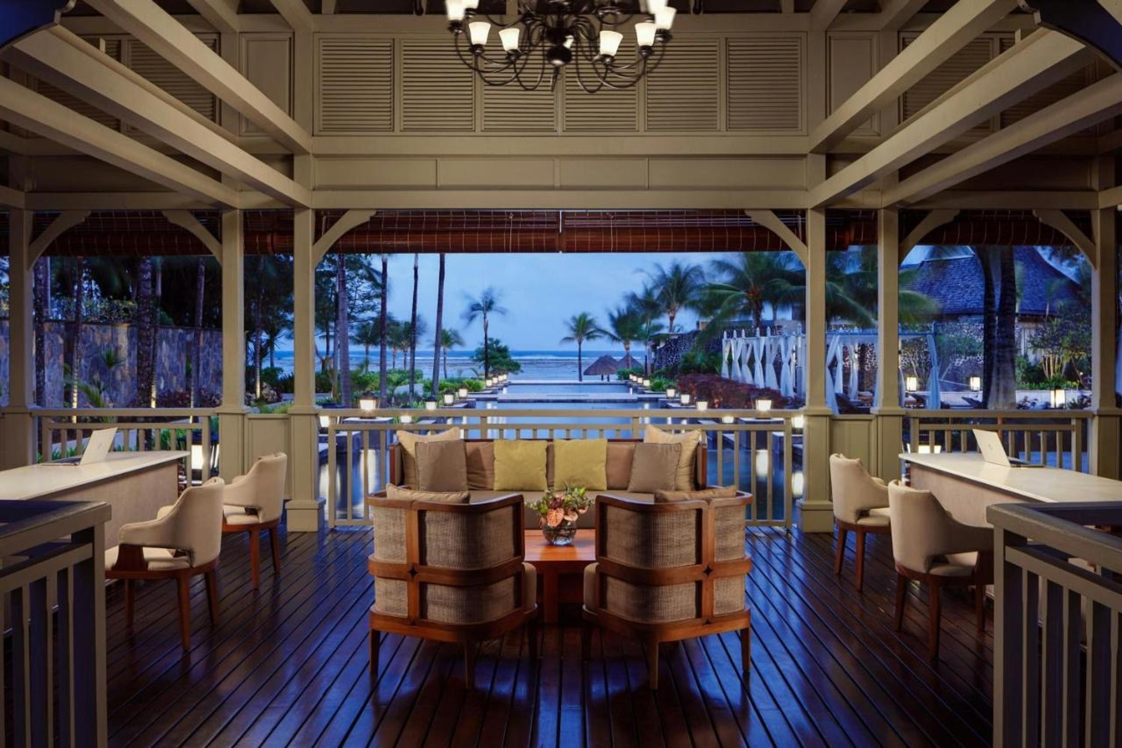An open pavilion with tables looking out to sea