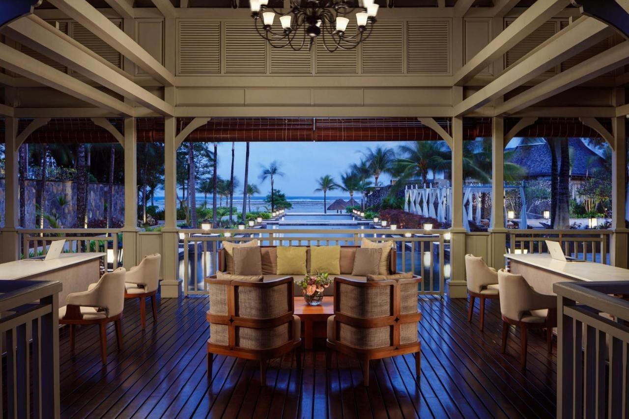 An open pavilion with tables looking out to sea