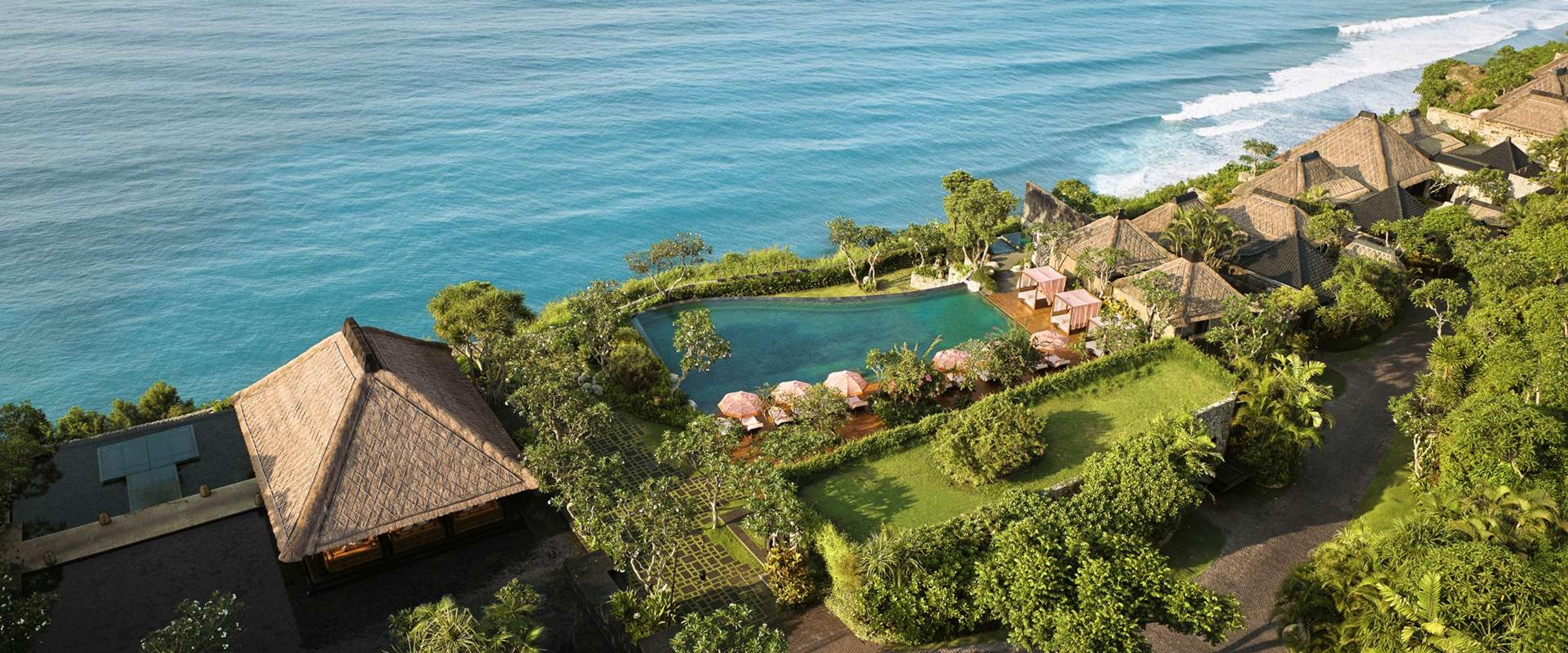 Bulgari Resort Bali's thatched villas and a pool on the clifftop above Uluwatu, the Indian Ocean beyond