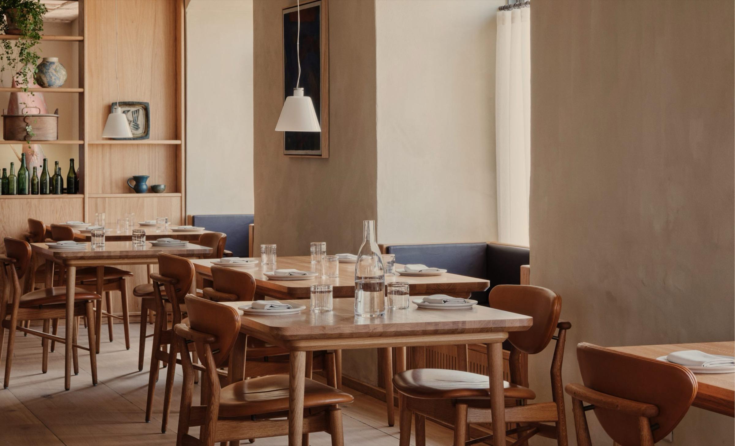 Barr's dining room in Copenhagen, plain wooden tables and chairs under pale walls