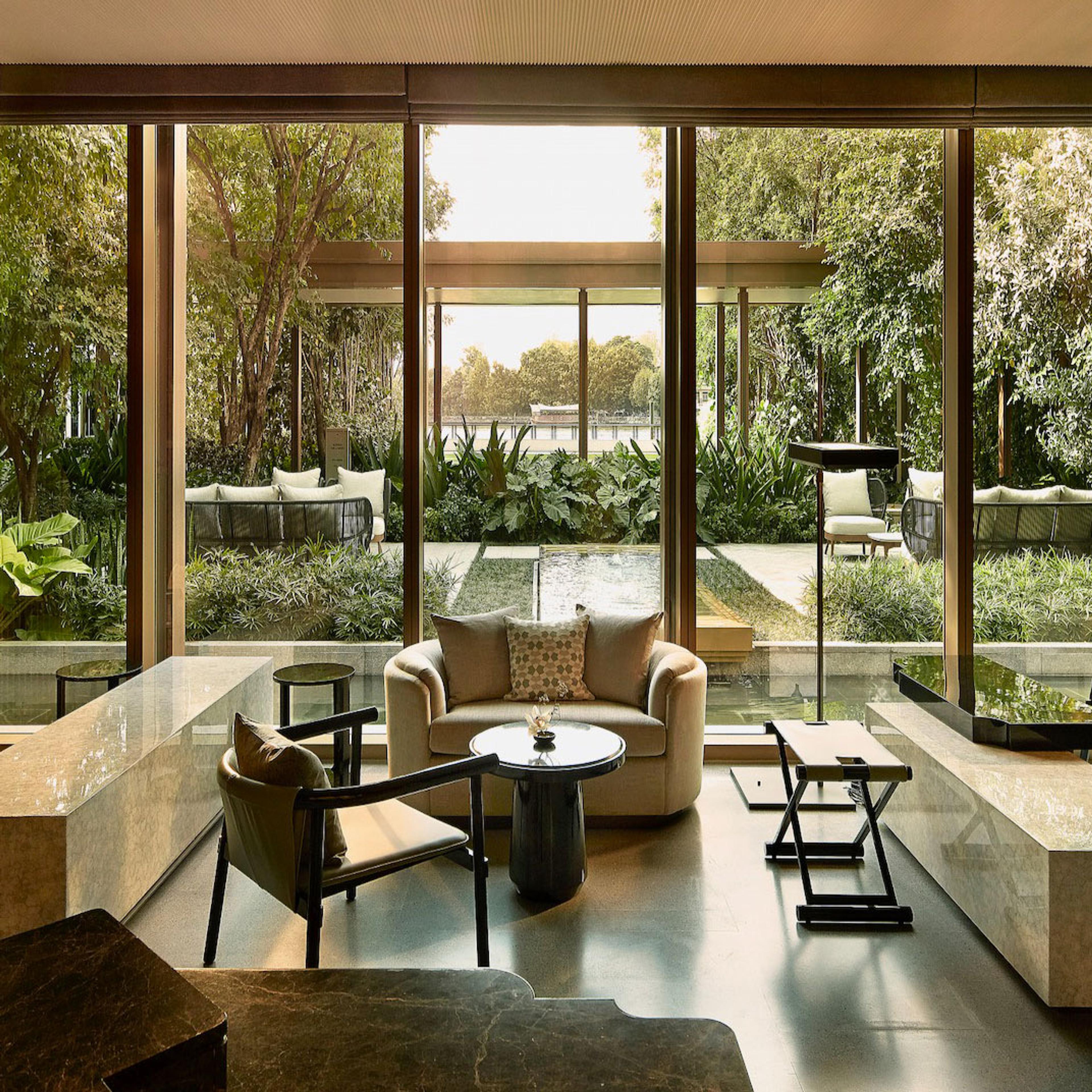 A garden courtyard with chairs among tall plants