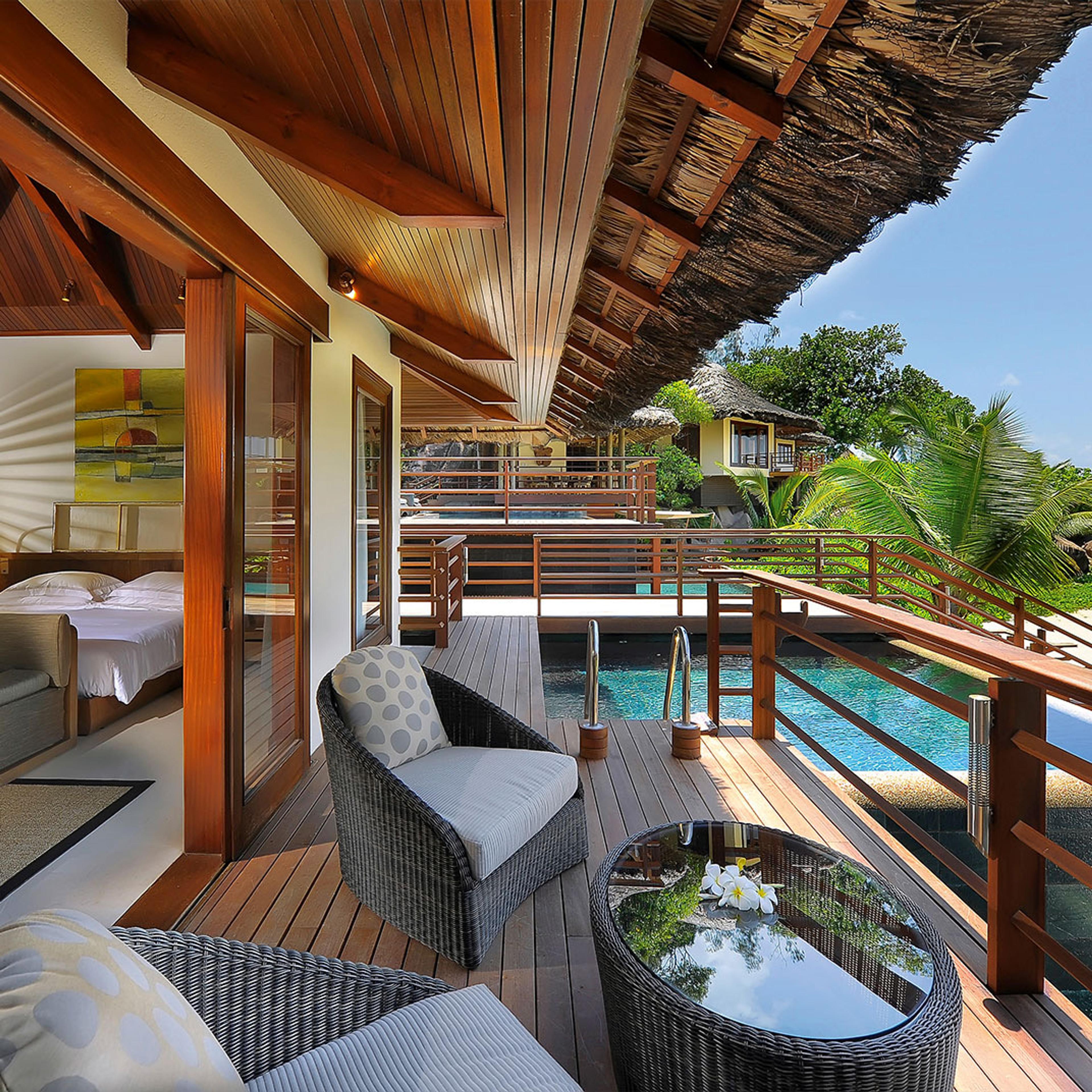A villa deck looking over its pool to the sea