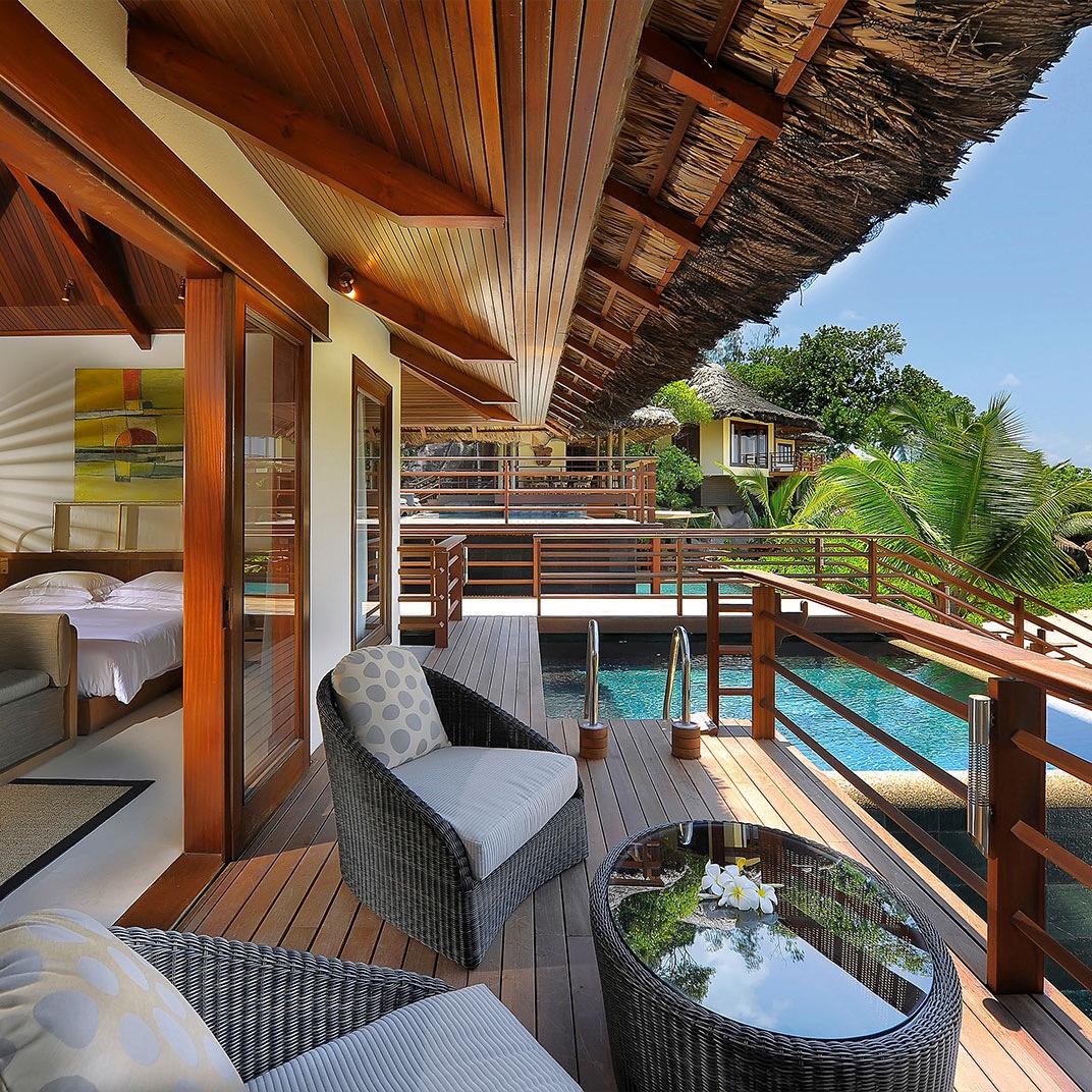 A villa deck looking over its pool to the sea