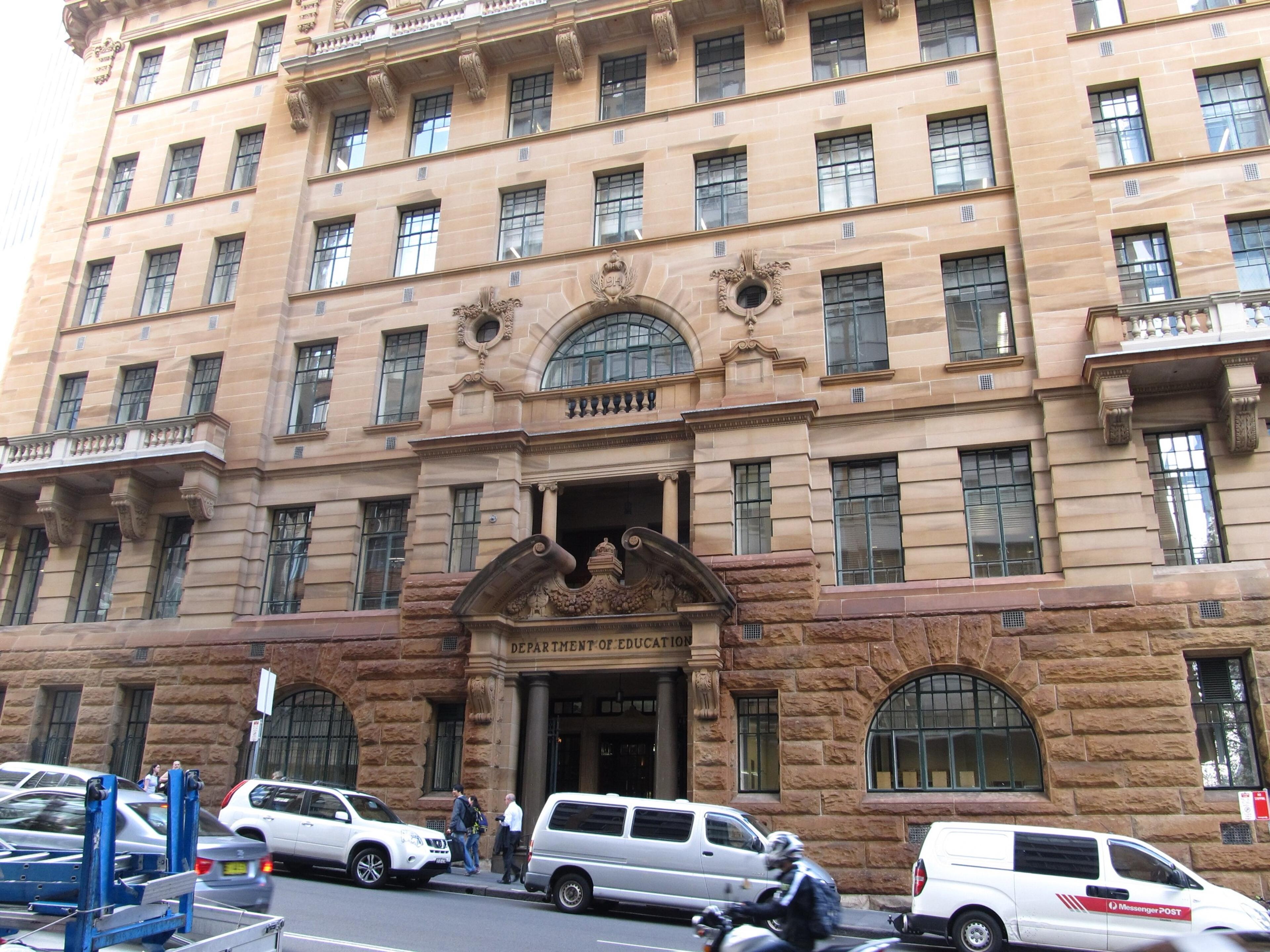 The building's long sandstone front on Bridge Street, with arched ground-floor windows