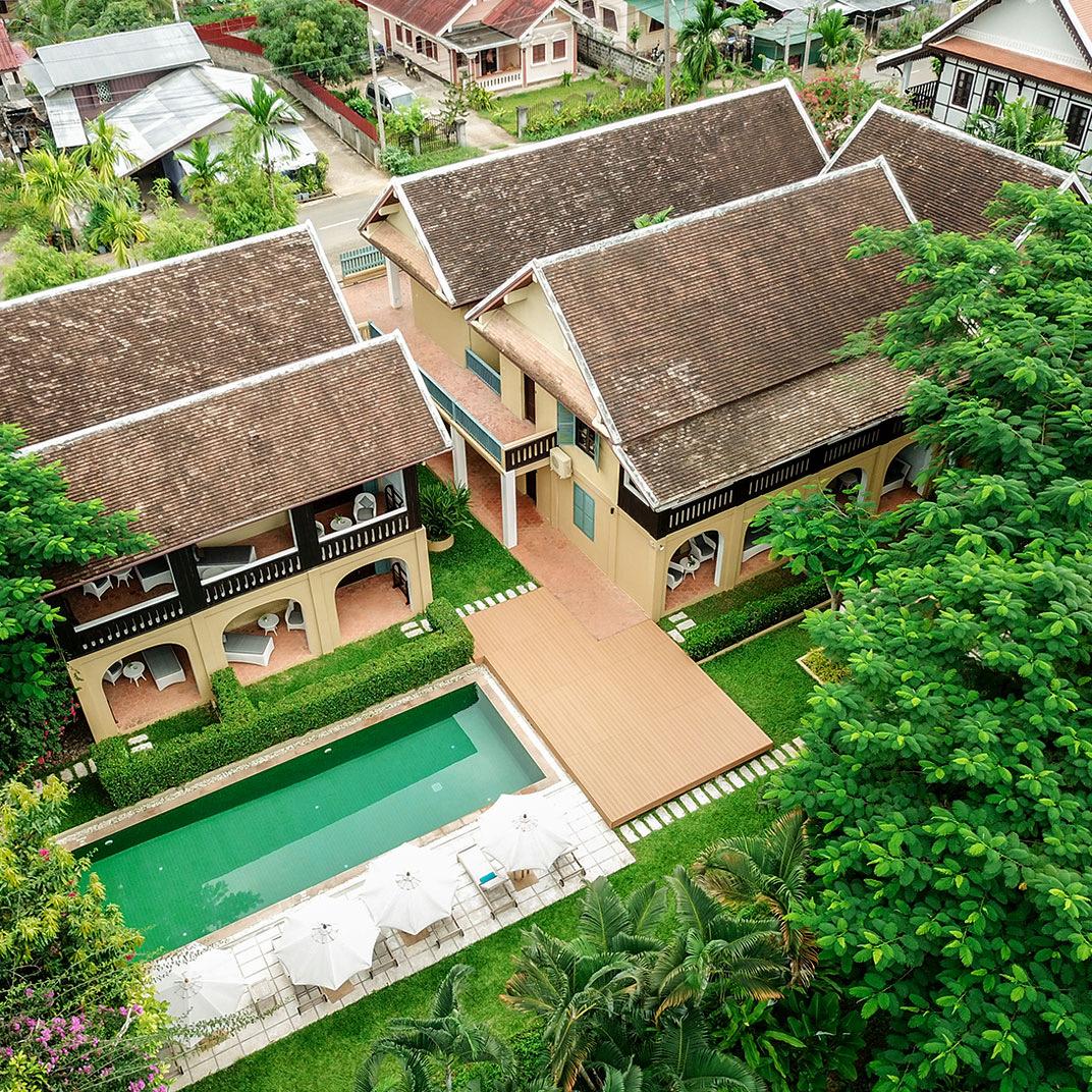 The hotel from above, tiled roofs round a green pool