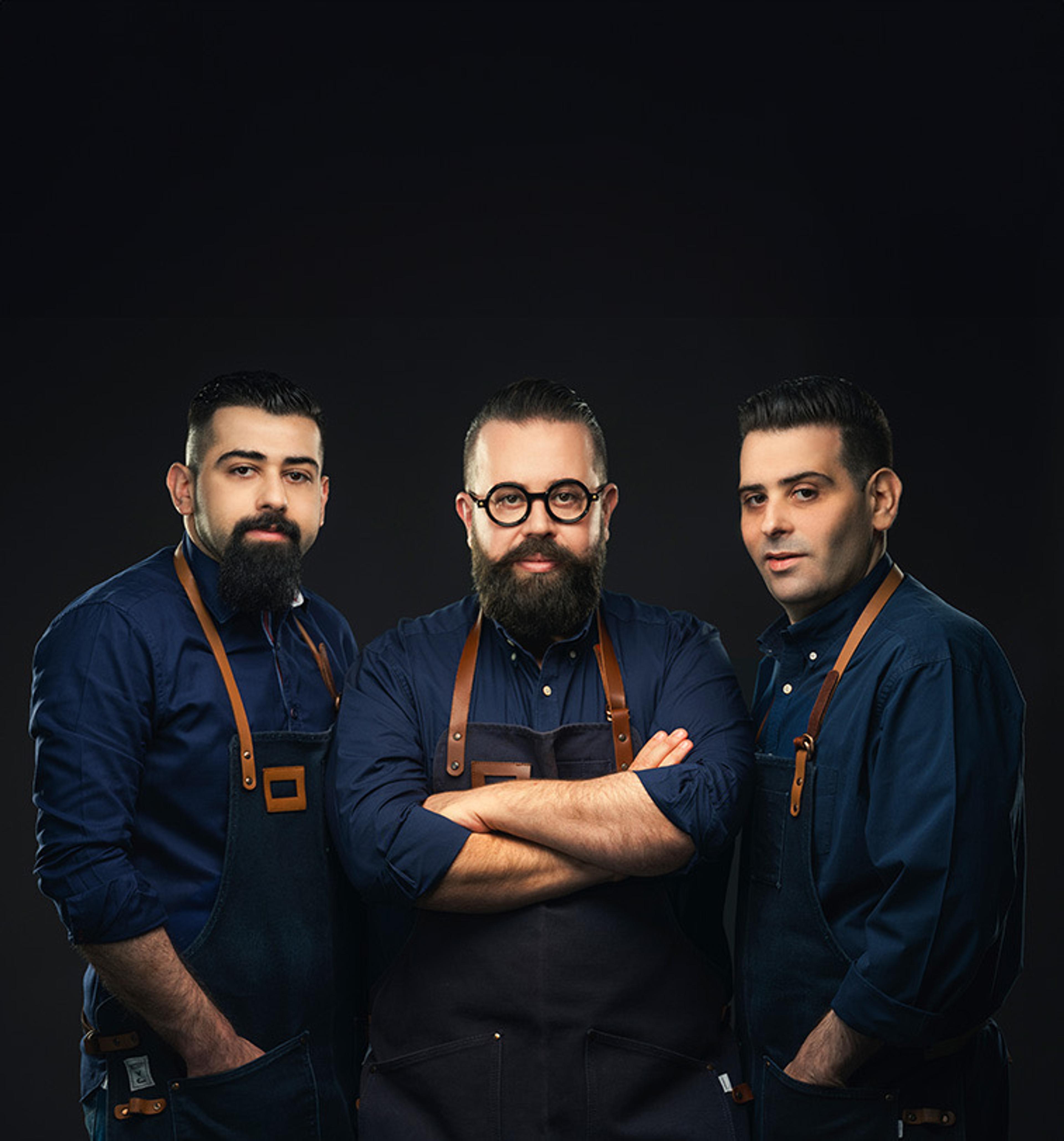 The three Orfali brothers in aprons
