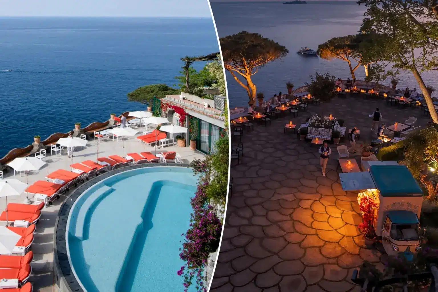 A curved pool terrace on the cliff at dusk, its lights on, with the sea and the coast beyond.