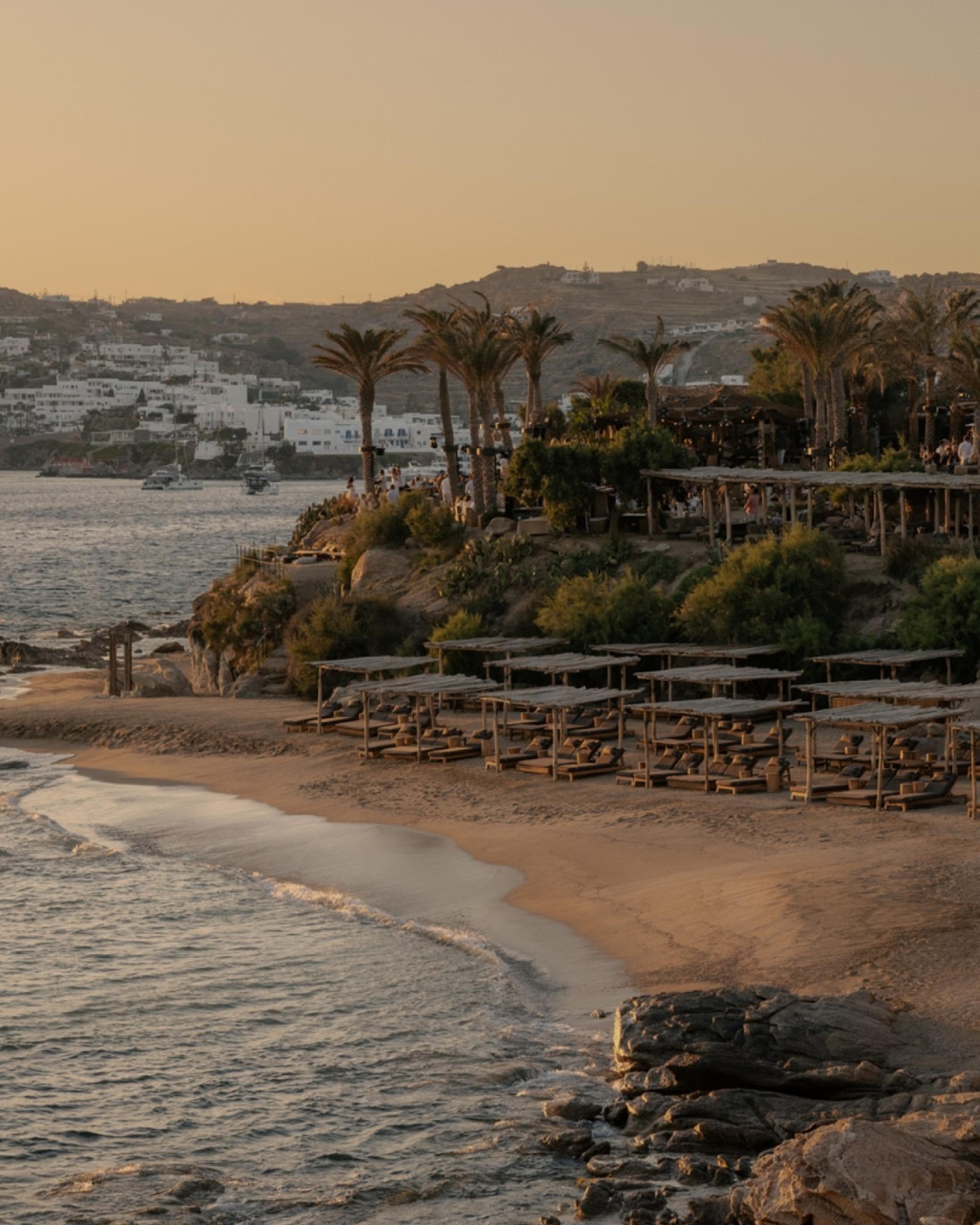 Scorpios's terraces above the beach at Paraga at dusk, the sea and the hills beyond