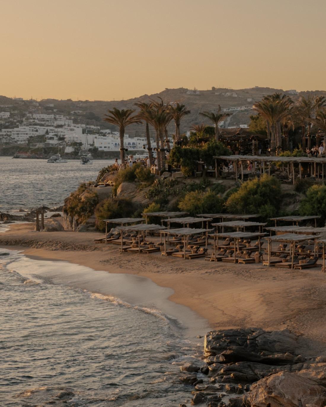 Scorpios's terraces above the beach at Paraga at dusk, the sea and the hills beyond