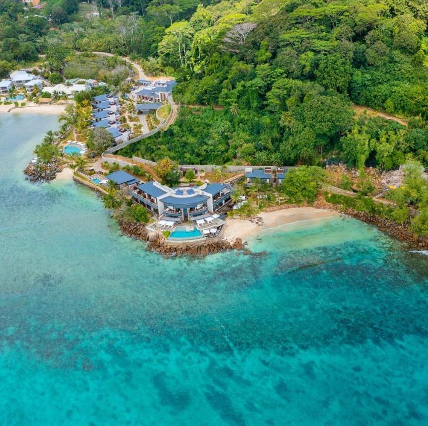 The hotel on its small bay from the air, the reef in the clear water