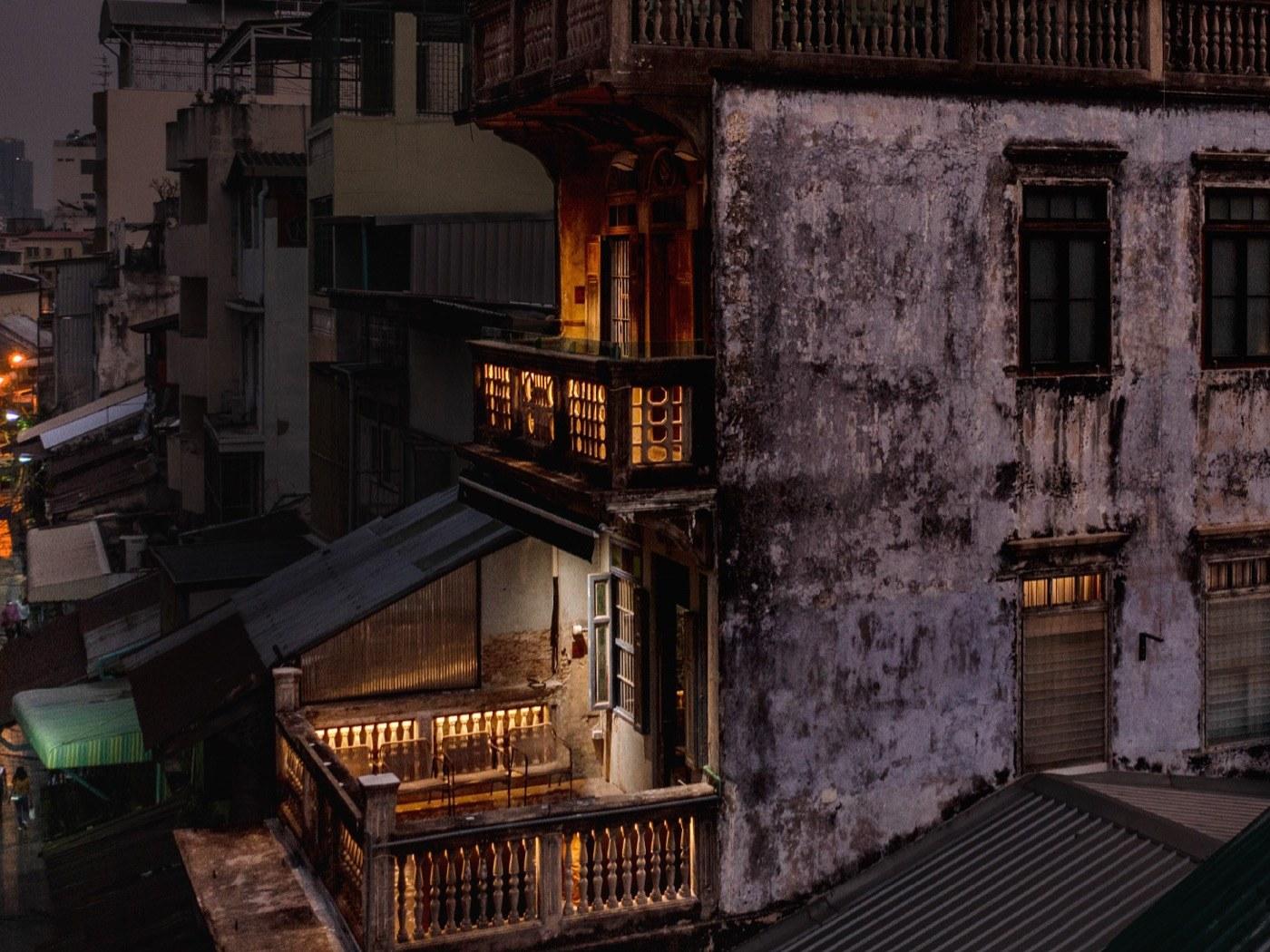 Old shophouses in Talat Noi at dusk, their windows lit
