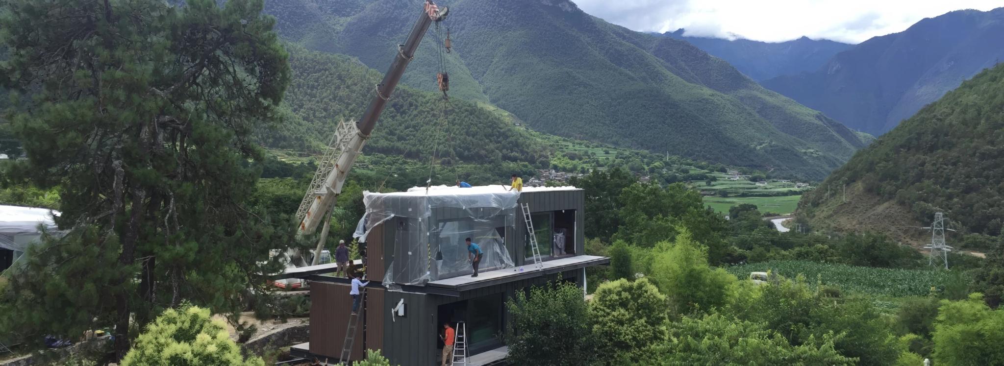 Modular home being installed in a mountain landscape