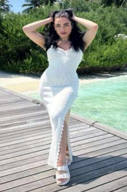 Bonnie Brunette European poses outside in a long white summer dress