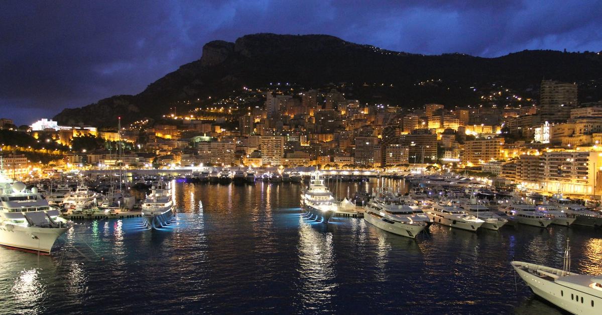 Yatchs parked in a mountainside harbor.