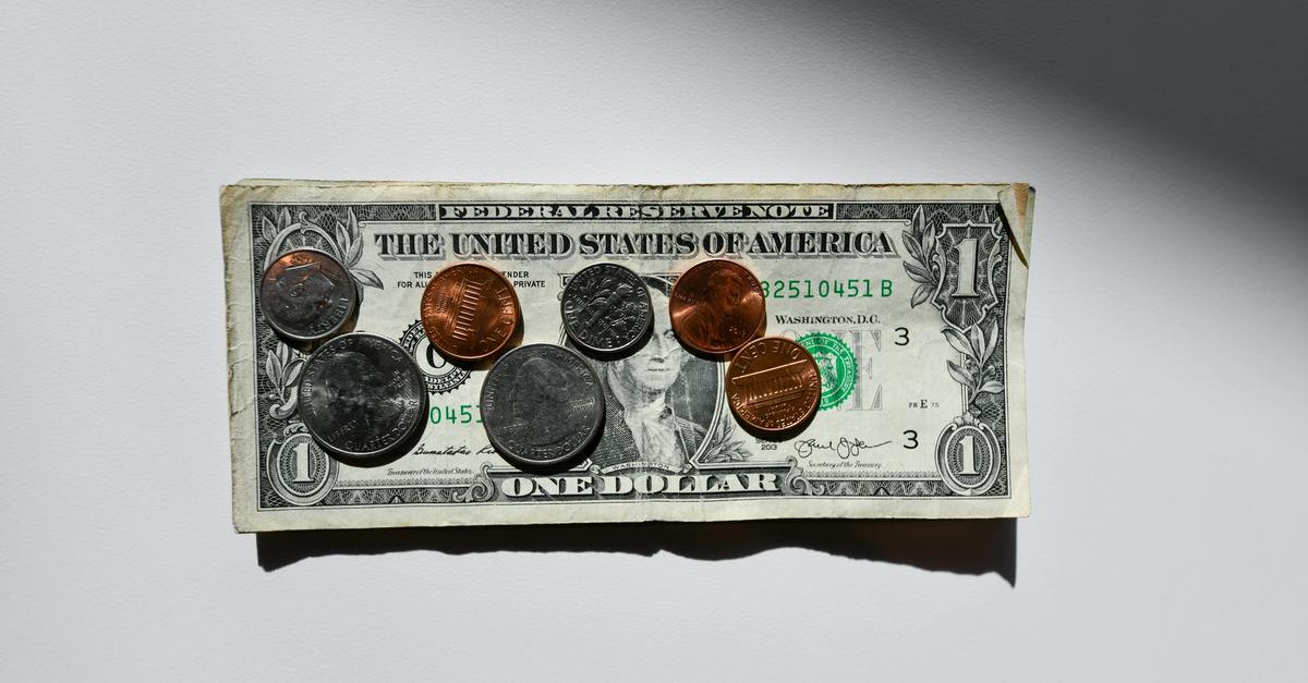 A $1 bill with change on top.