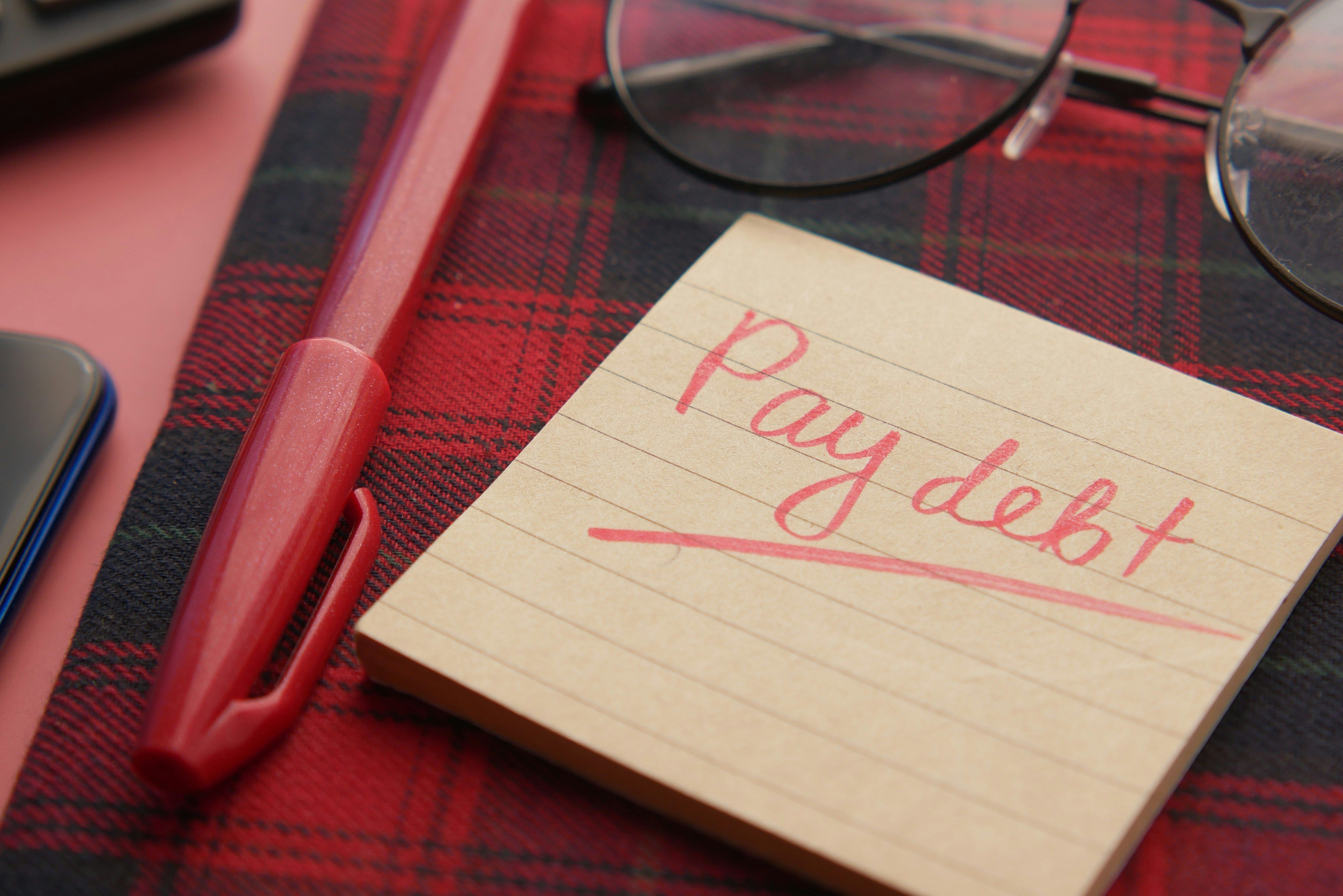 Posted note that says pay debt on it by Towfiqu Barbhuiya.