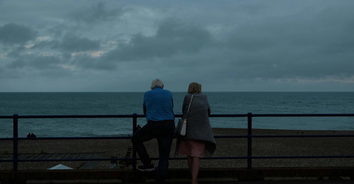 Couple on beach pier contemplating divorce by Al Elmes.
